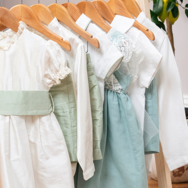 White and light green dresses on wooden hangers