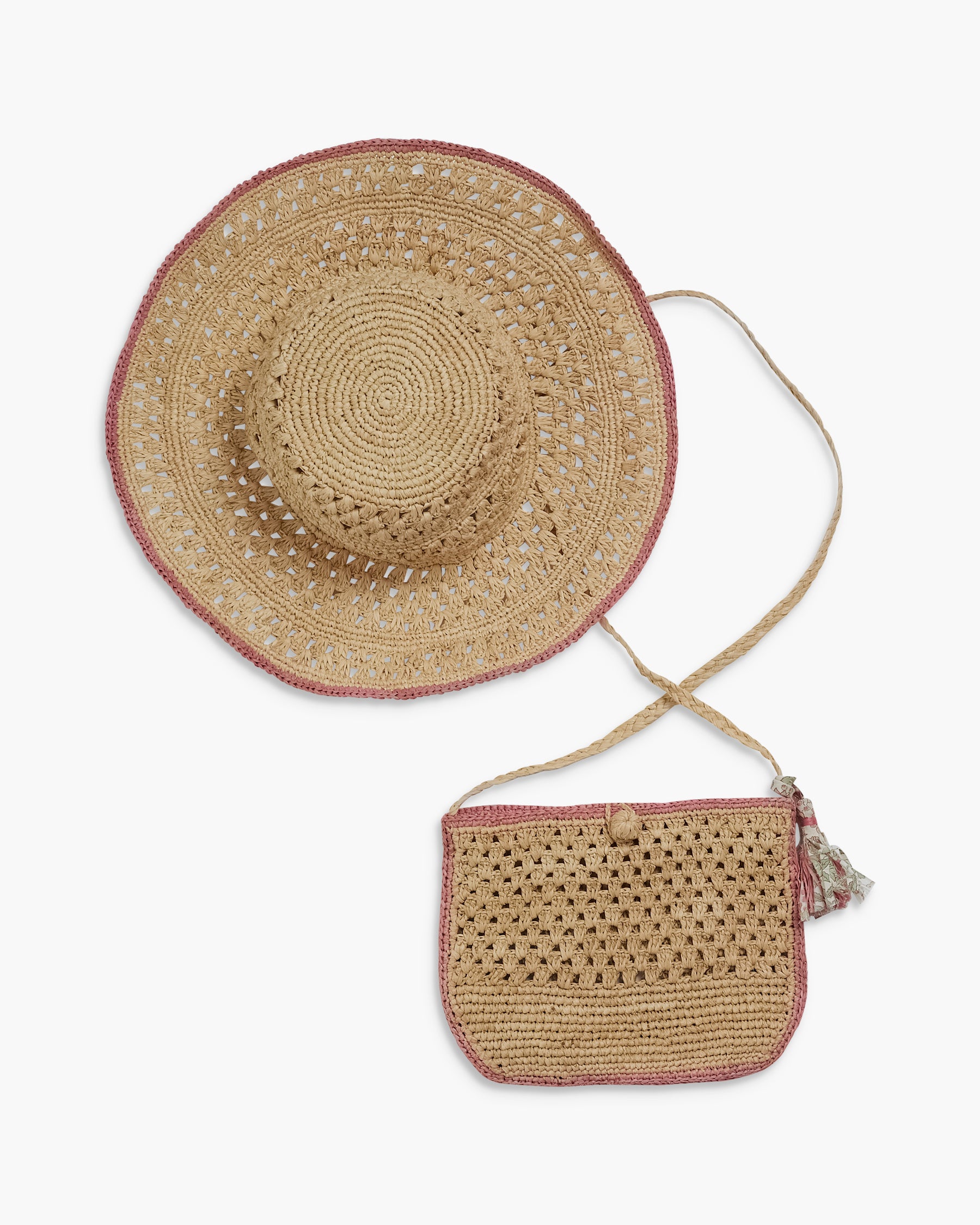 Woven straw hat and bag set on a white background