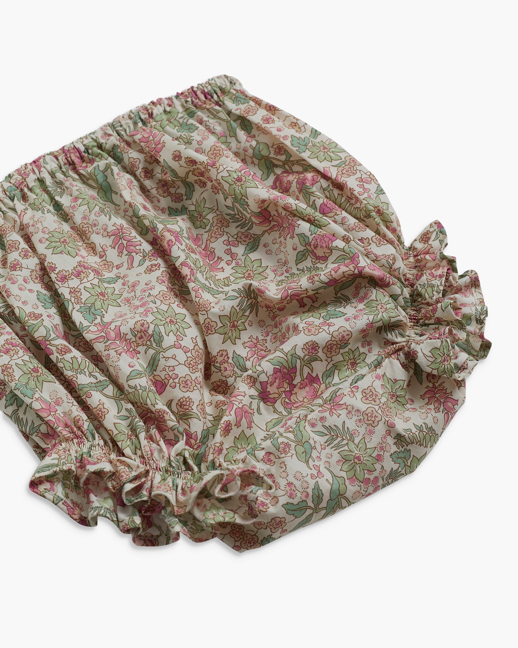 Floral patterned baby bloomers on a white background