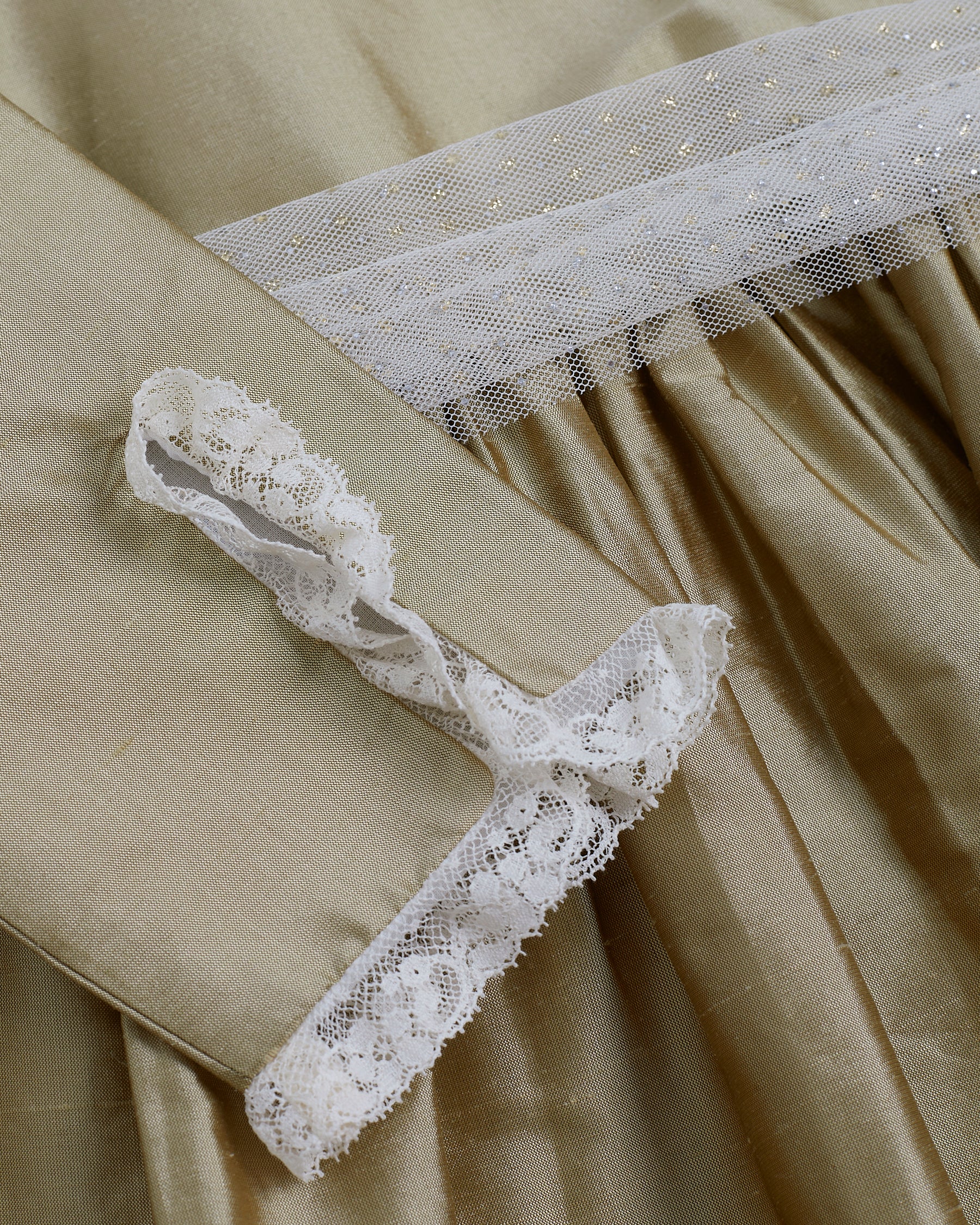 White lace garter on a beige fabric background