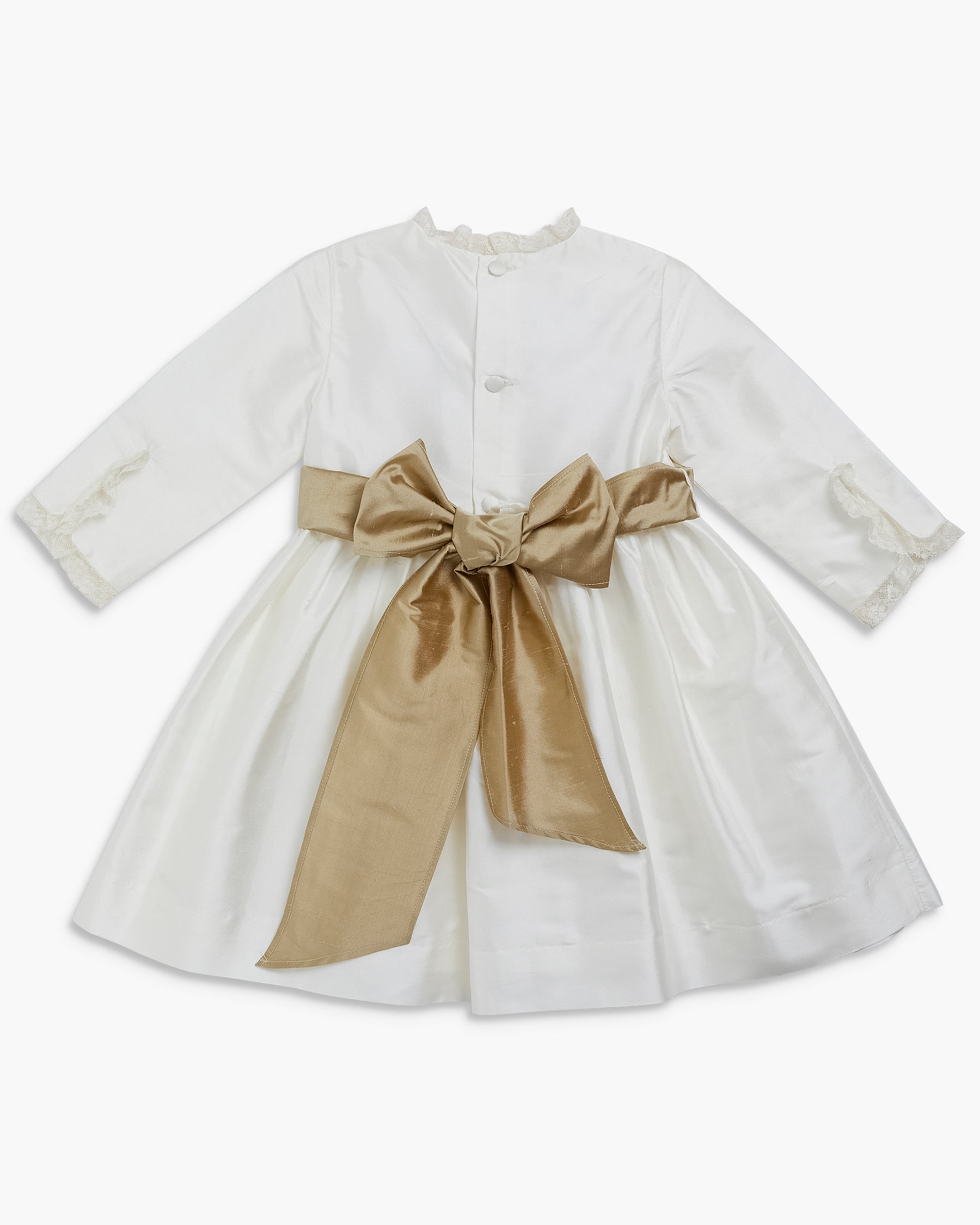 White dress with a large gold bow on a white background