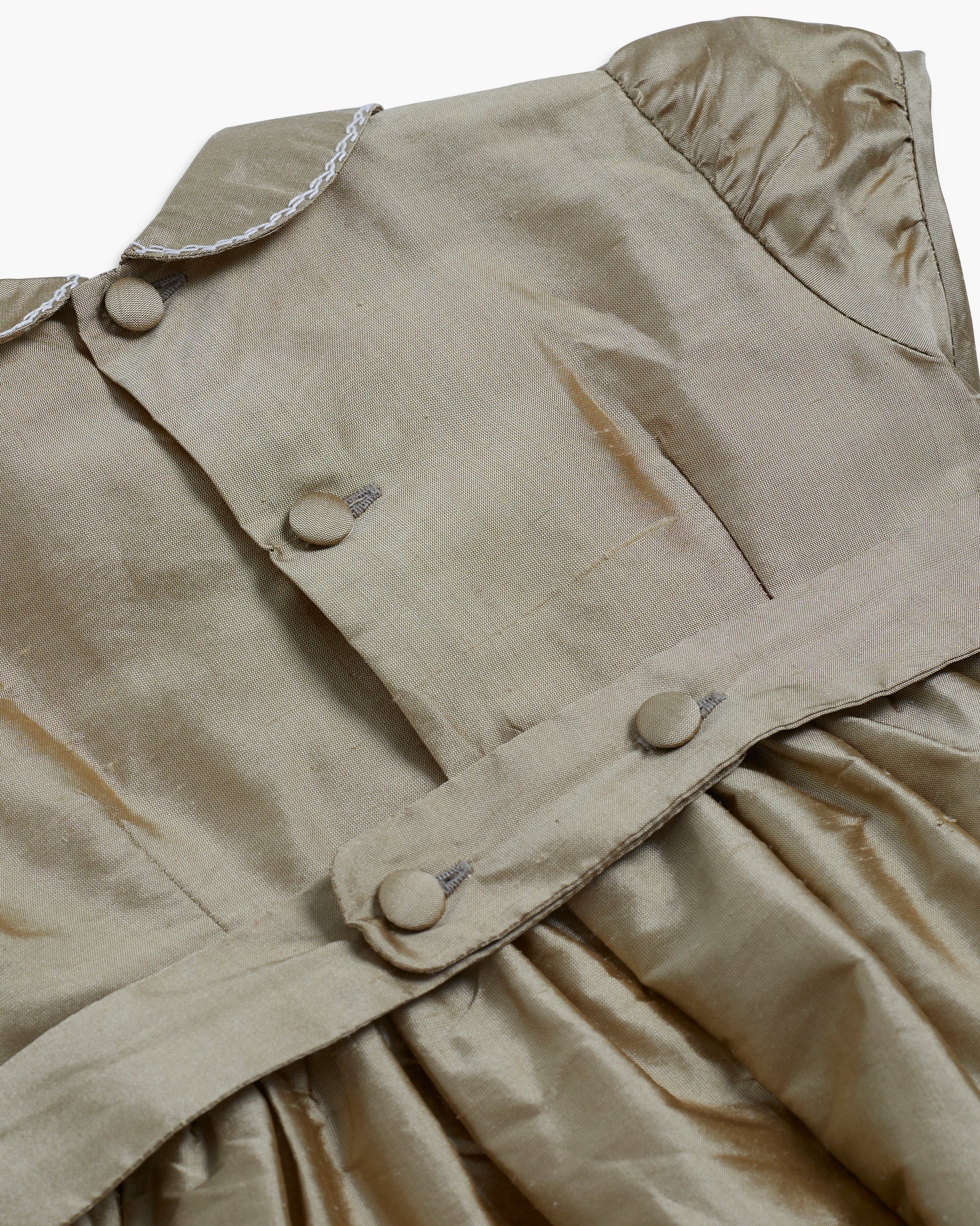 Beige jacket with buttons on a plain background