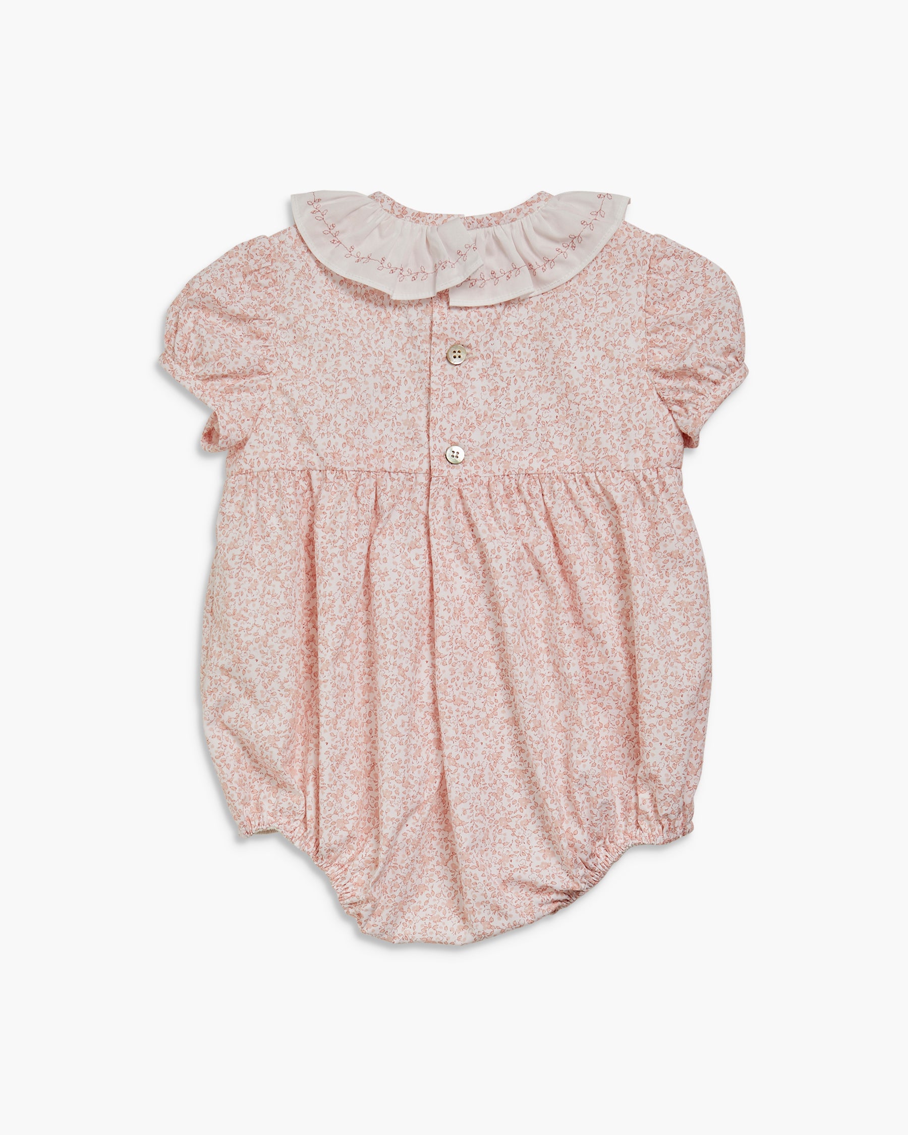 Baby romper with floral pattern and ruffled collar on a white background