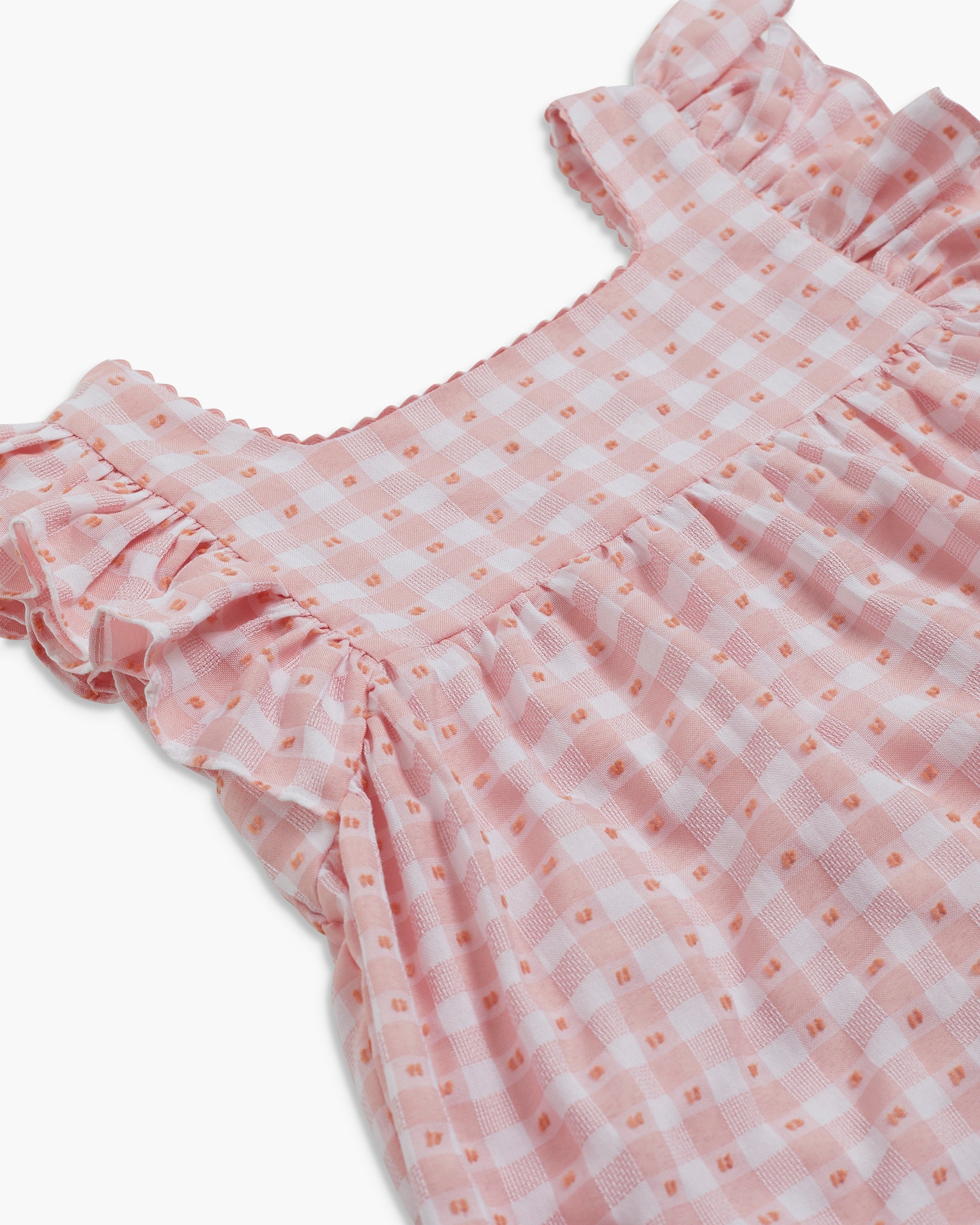 Pink checkered dress with ruffled details on a white background