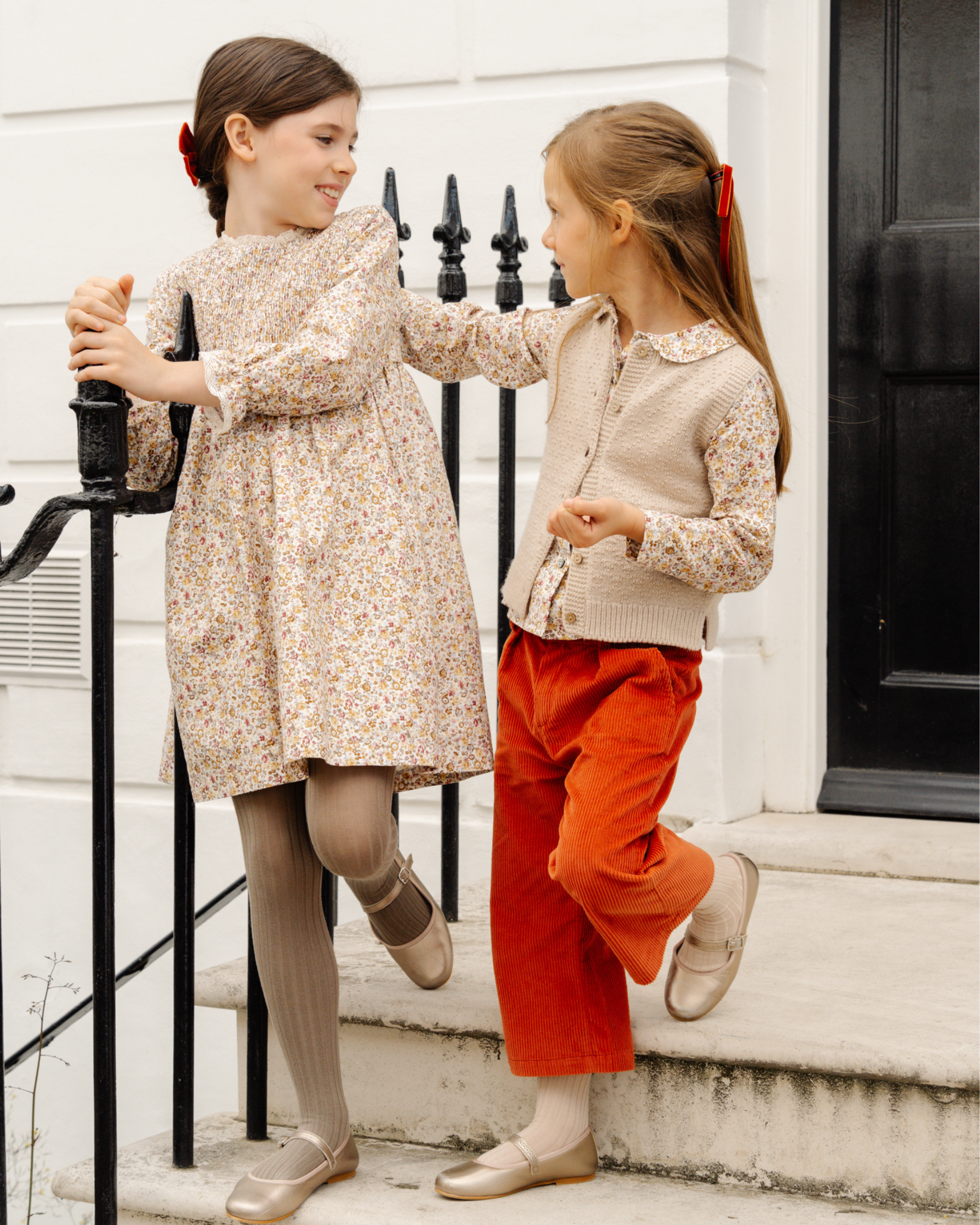 Girl wearing a dress and girl wearing trousers Burnt Orange corduroy