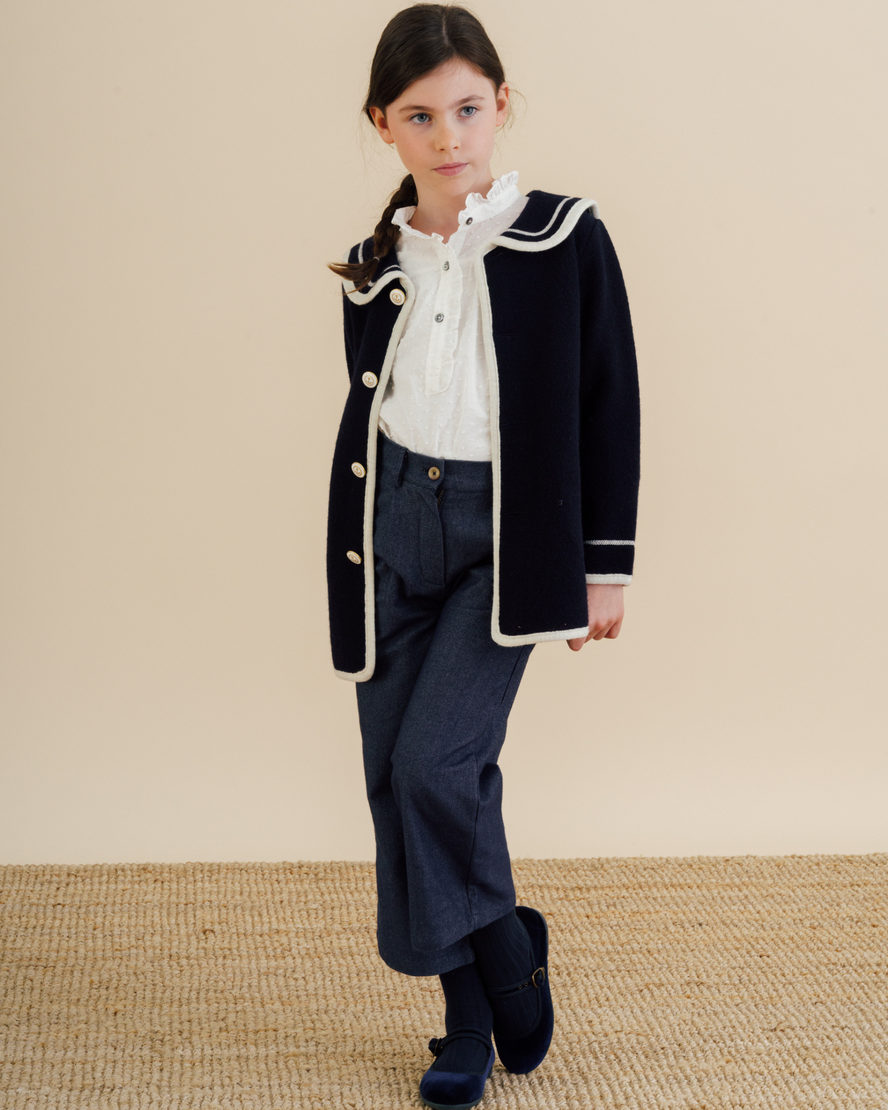 Girl wearing trousers in soft navy twill fabric with blouse and jacket