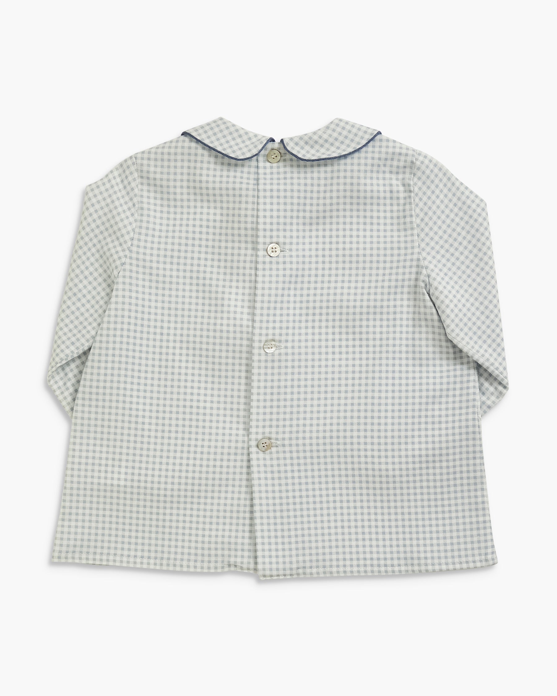 A long-sleeve button-front shirt for a child, featuring a fine light gray and white gingham check pattern, a Peter Pan collar with dark blue trim, and light-colored buttons.