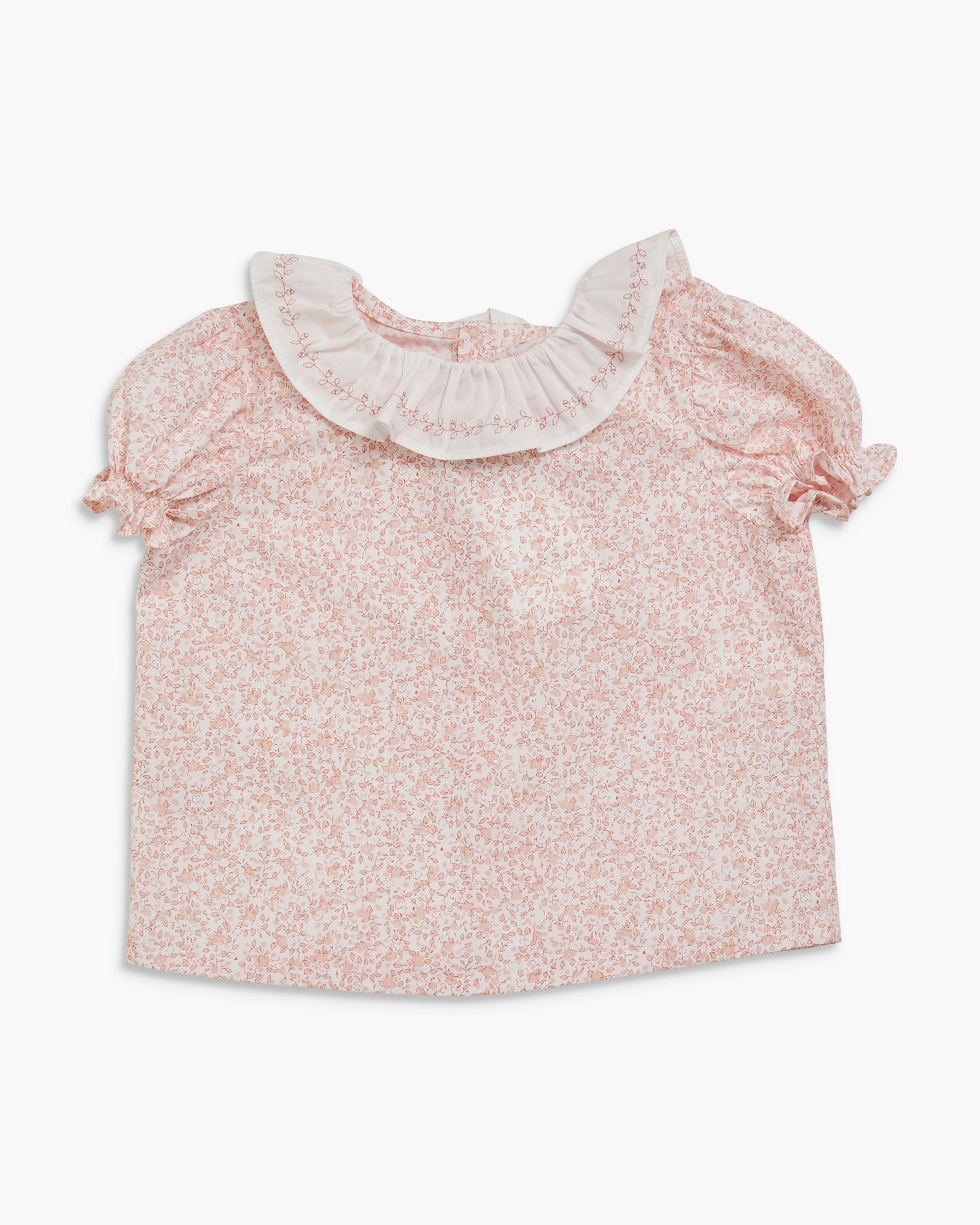 Pink floral blouse with a ruffled collar on a white background