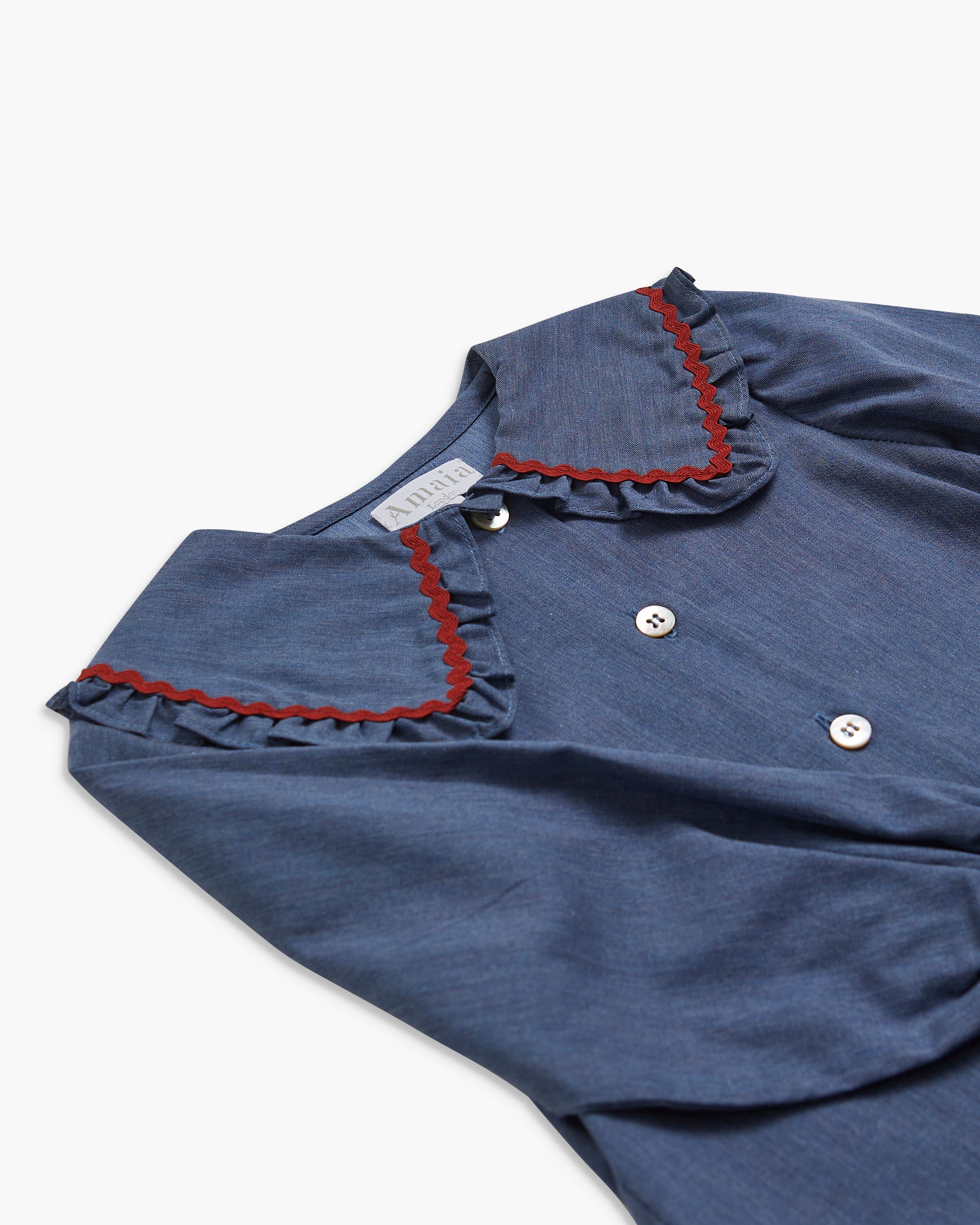 Blue dress with red trim on a white background