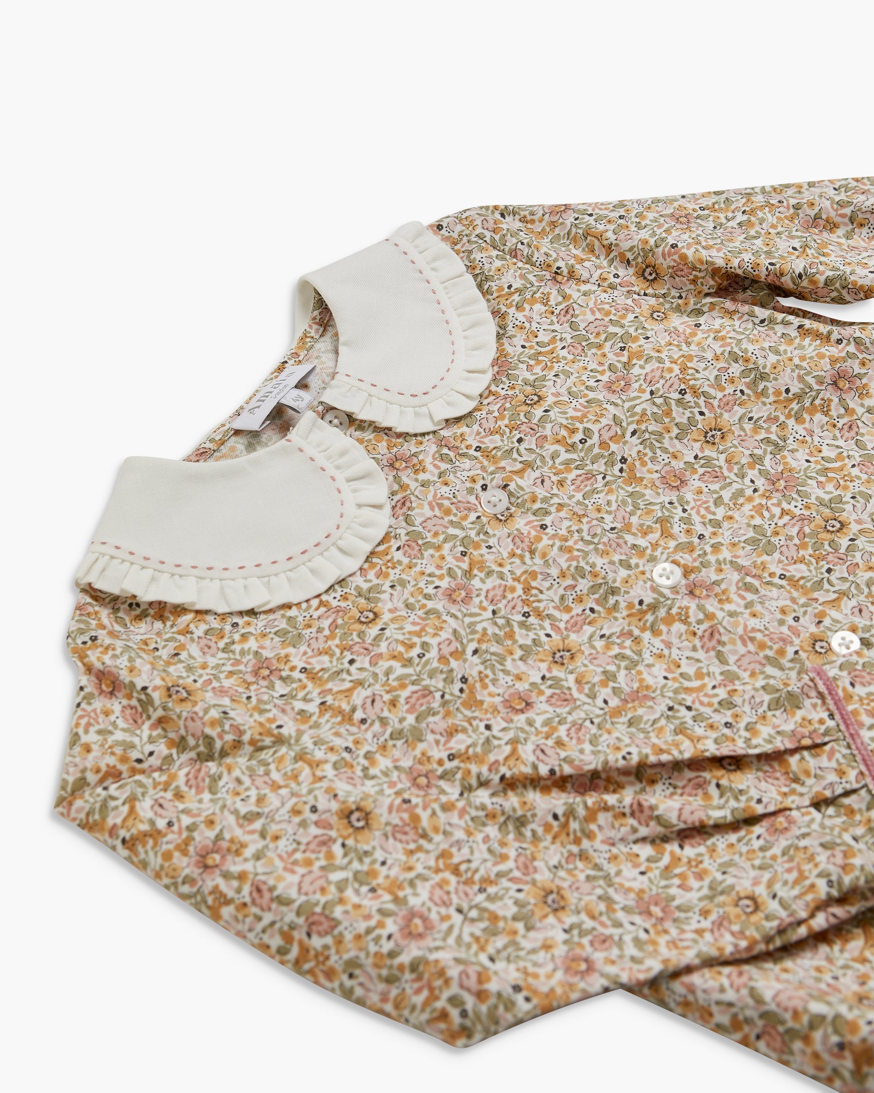 Floral dress with a white collar on a white background