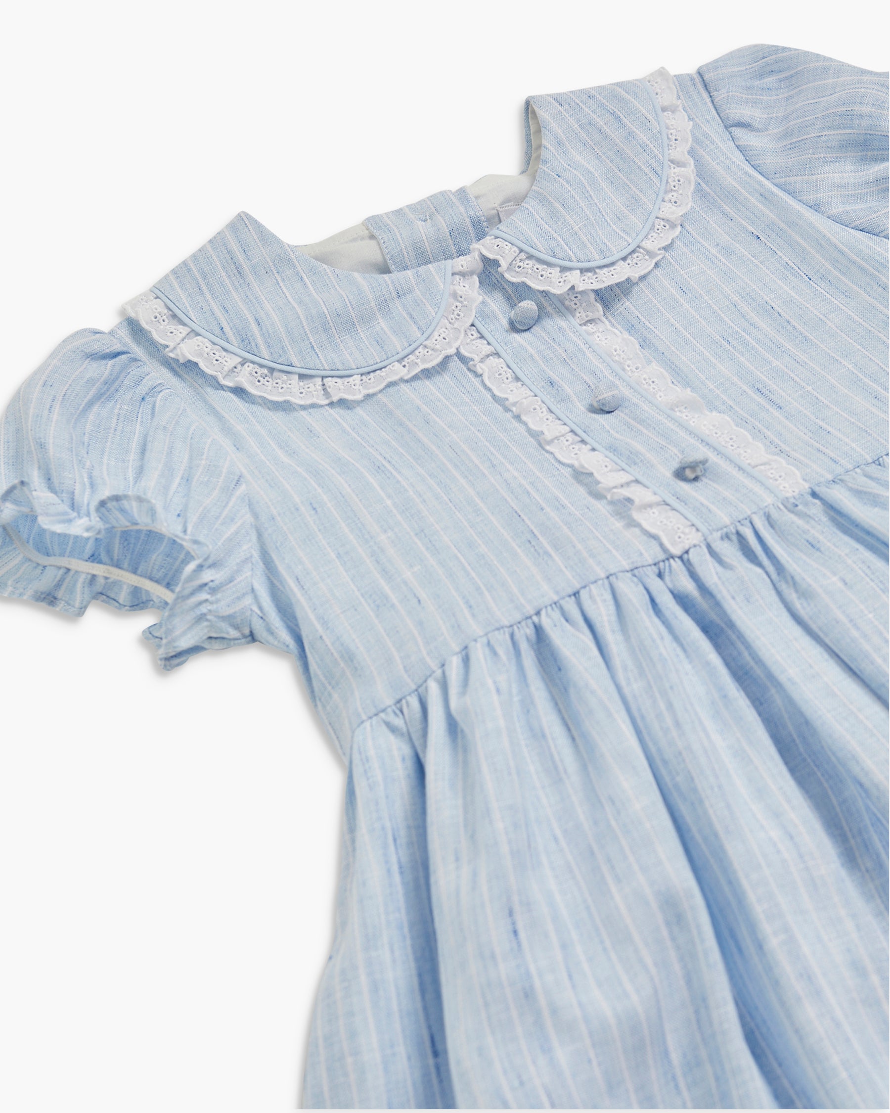 Light blue dress with lace details on a white background