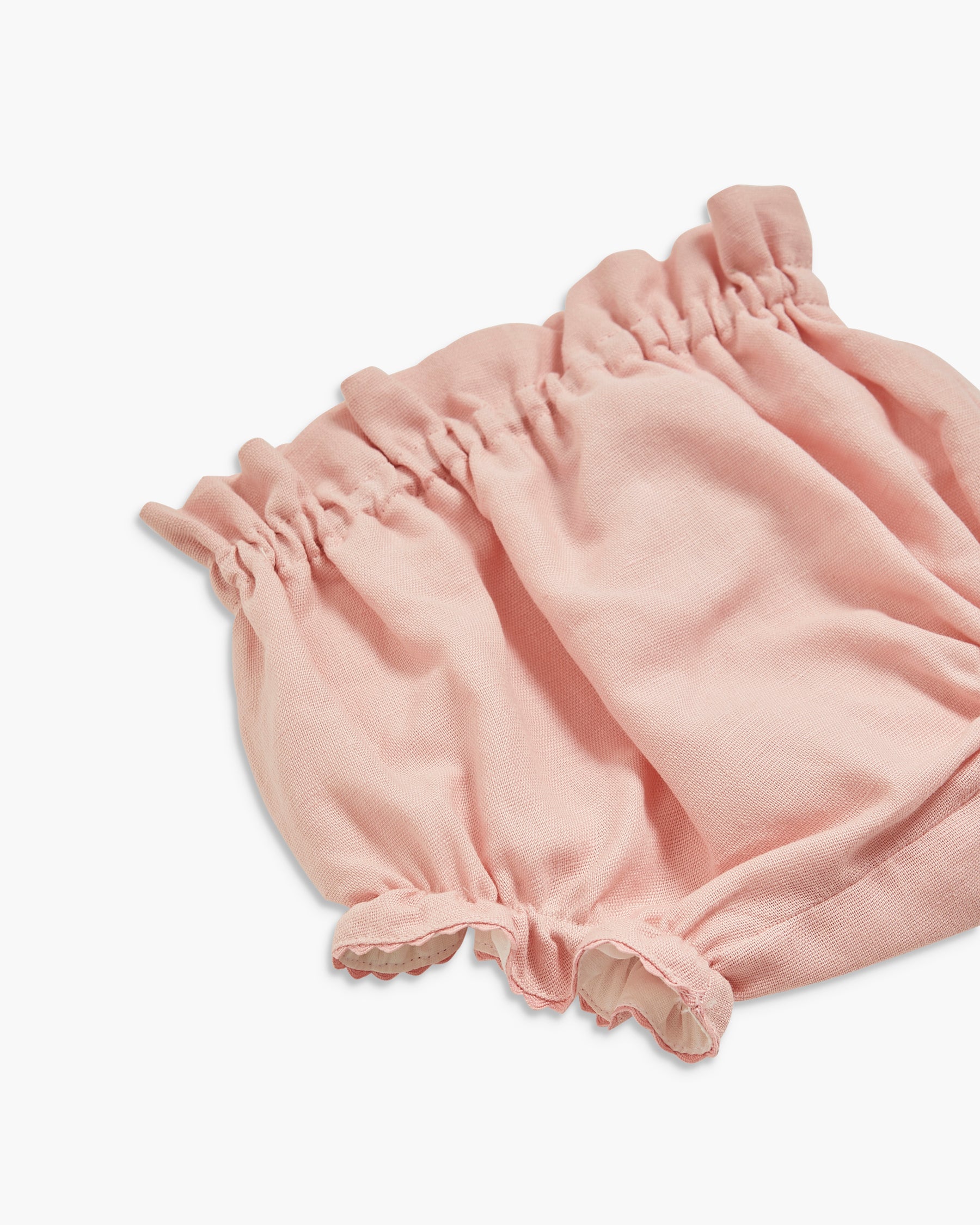 Pink baby bloomers on a white background