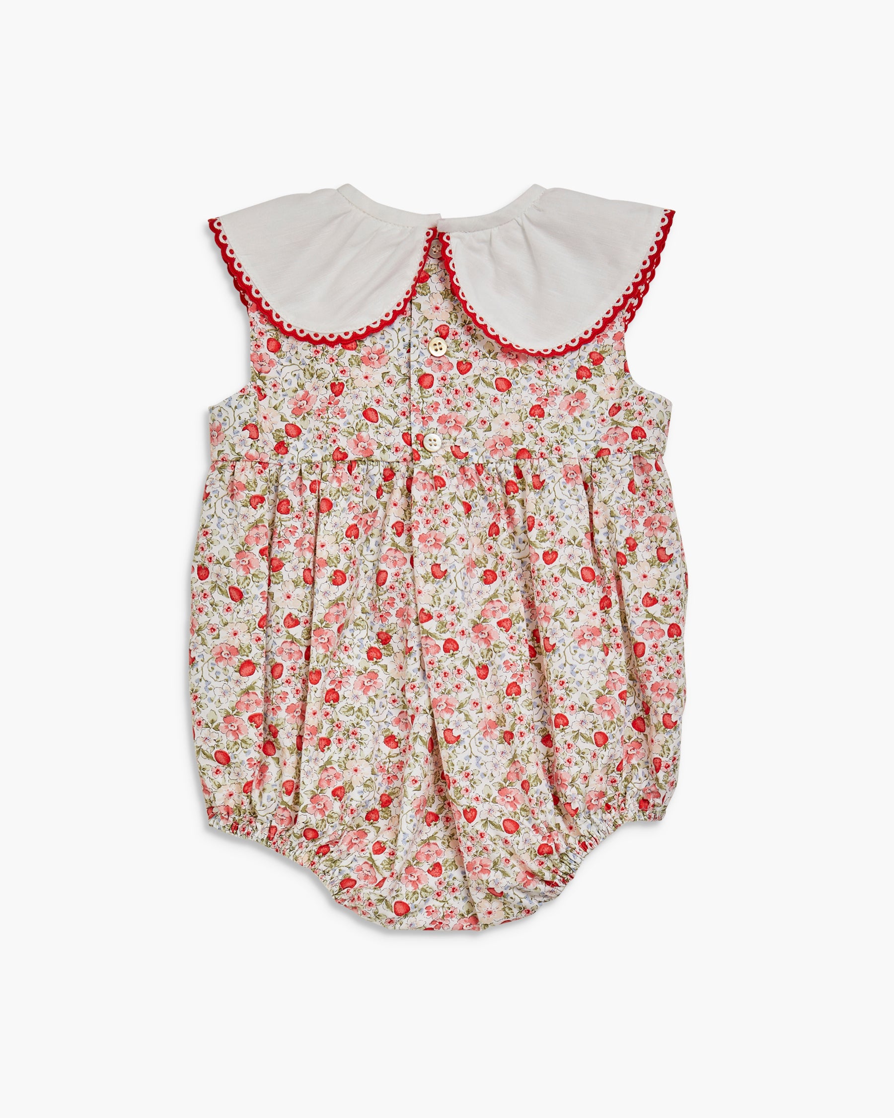 Floral baby romper with red trim on a white background