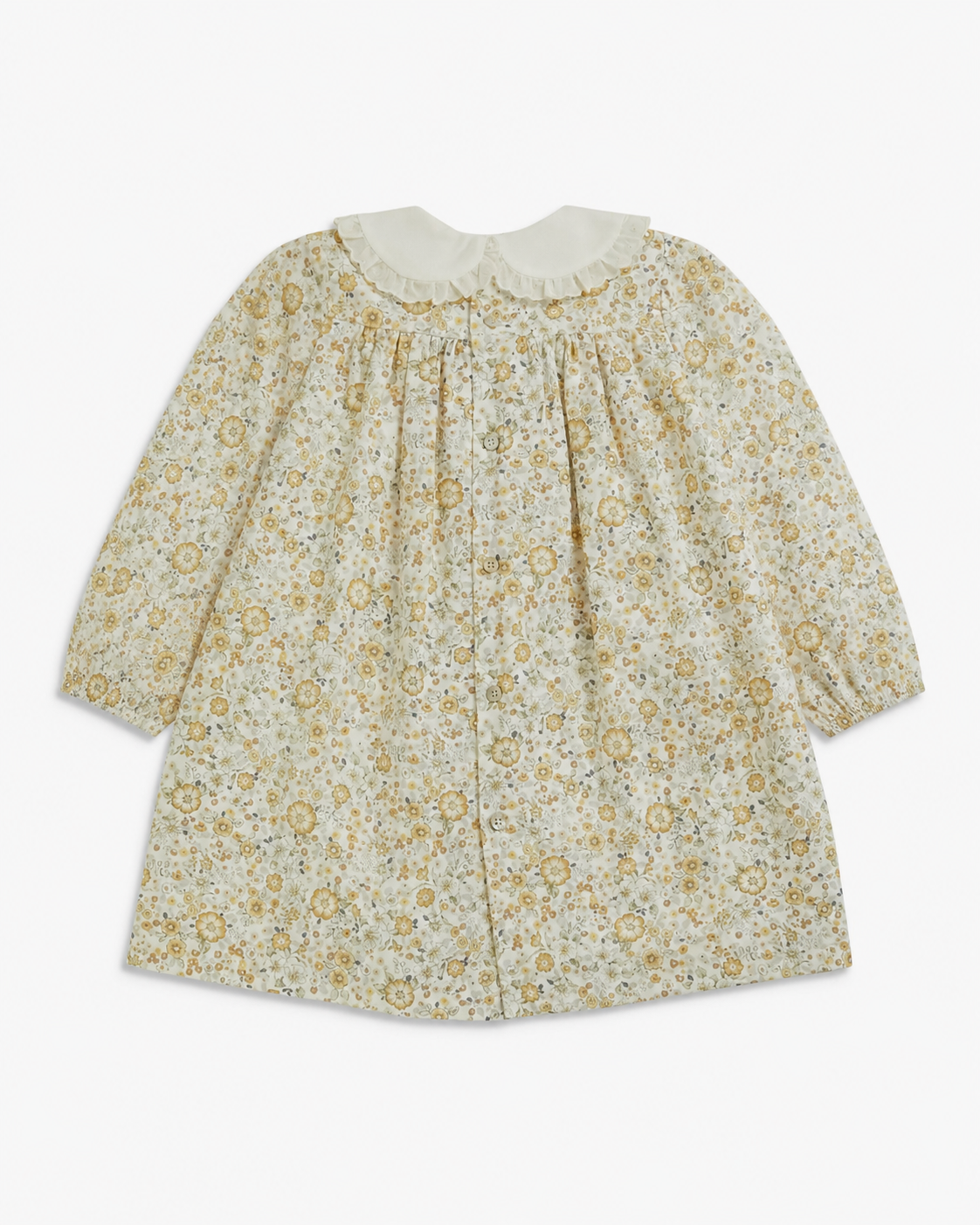 A long-sleeve baby dress with a delicate yellow and green floral pattern on a cream background, featuring a ruffled cream collar and a gathered front.