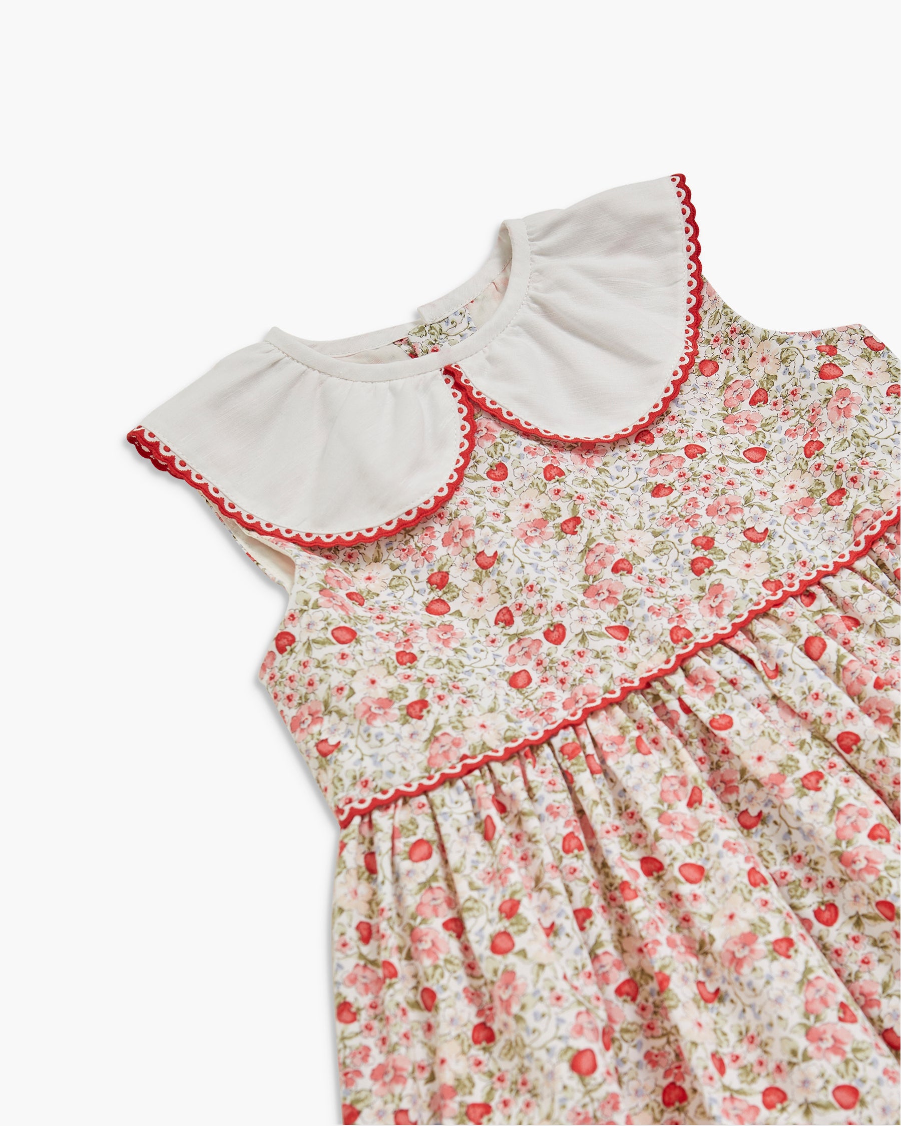 Floral dress with red trim on a white background
