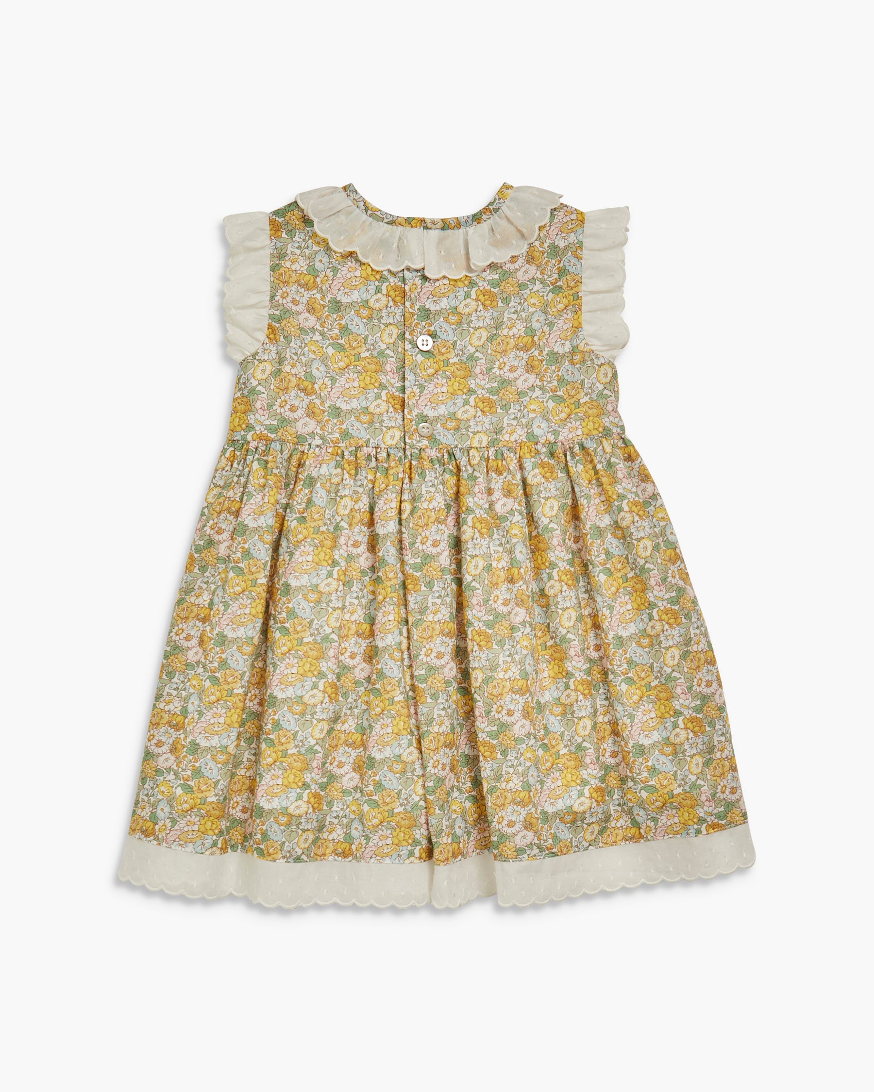 Yellow floral dress with white trim on a white background