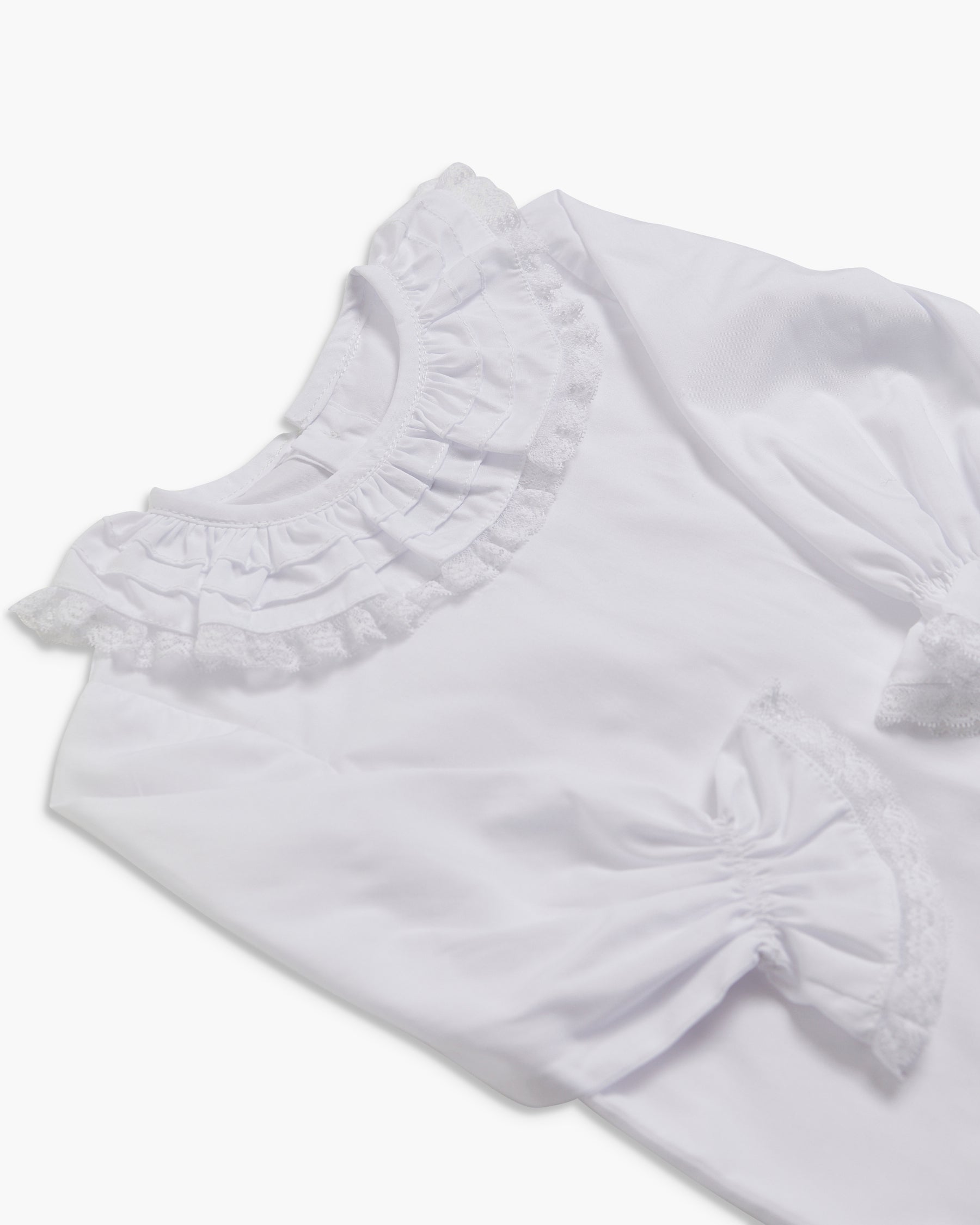 White blouse with ruffled details on a white background