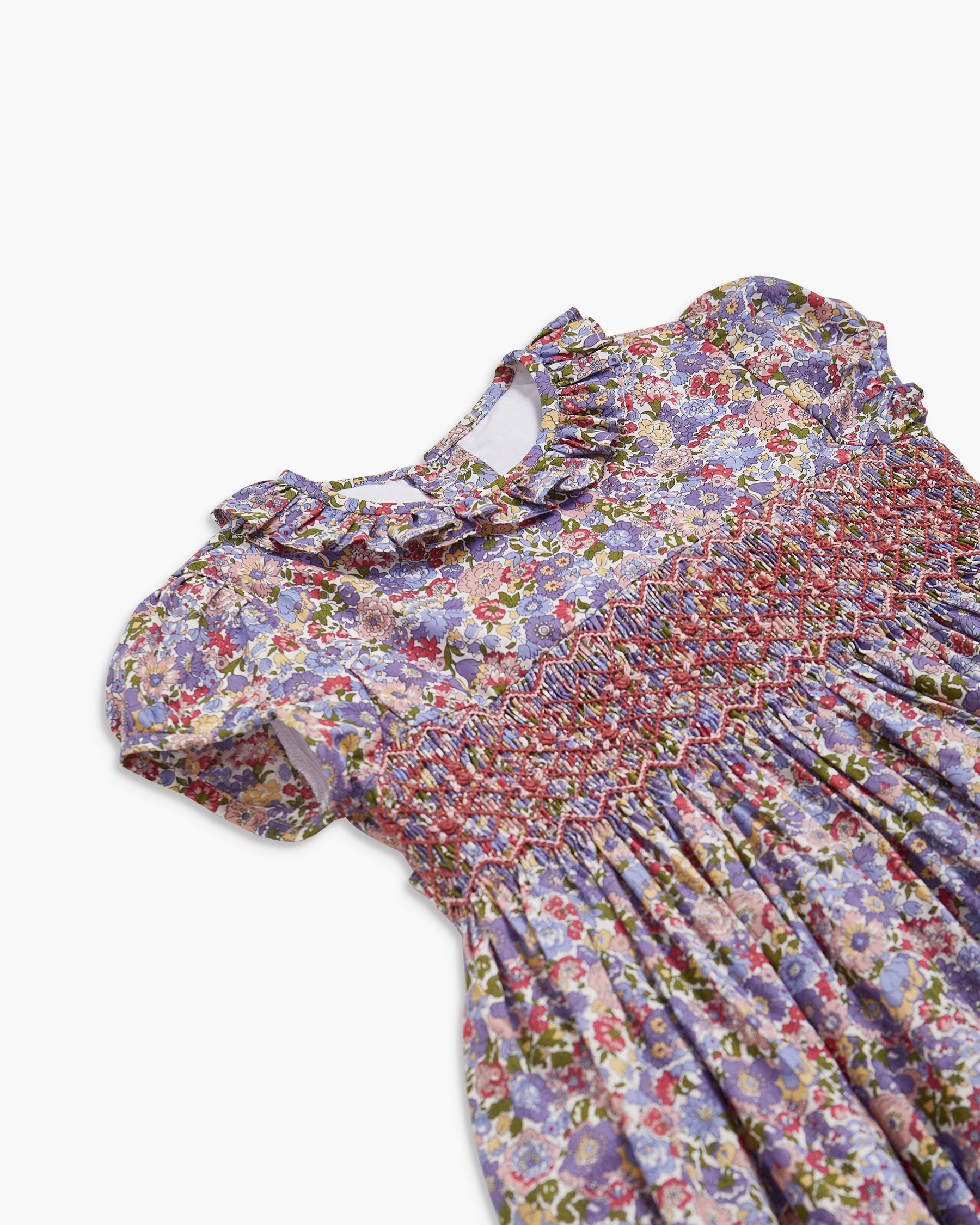 Floral dress with a ruffled neckline on a white background