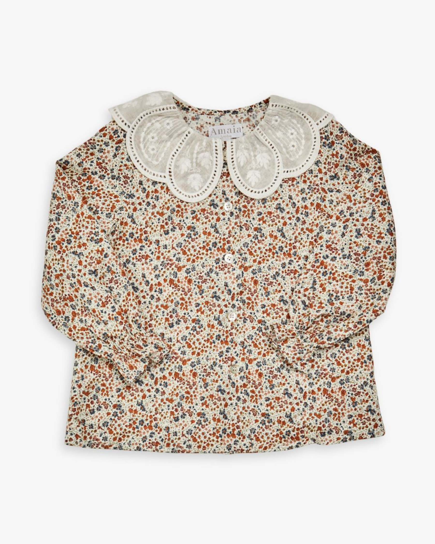 Floral blouse with lace collar on a white background