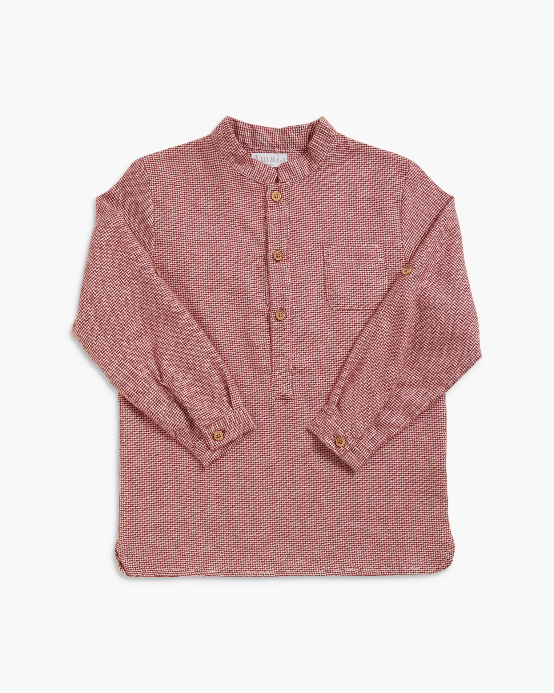 A long-sleeve button-up shirt in a dusty rose pink and white micro-check pattern, featuring a mandarin collar, three brown buttons, and a chest pocket, laid flat against a light gray background.