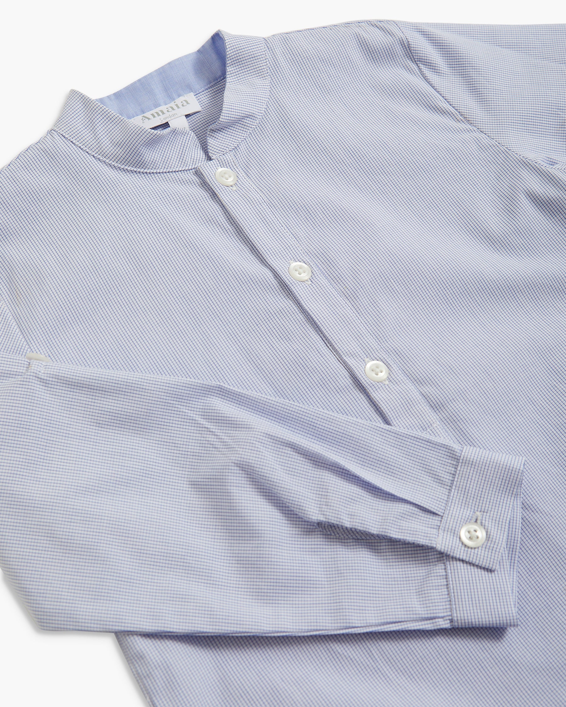 A close-up of a light blue and white micro-striped long-sleeve button-up shirt with a mandarin collar, laid flat on a white background.