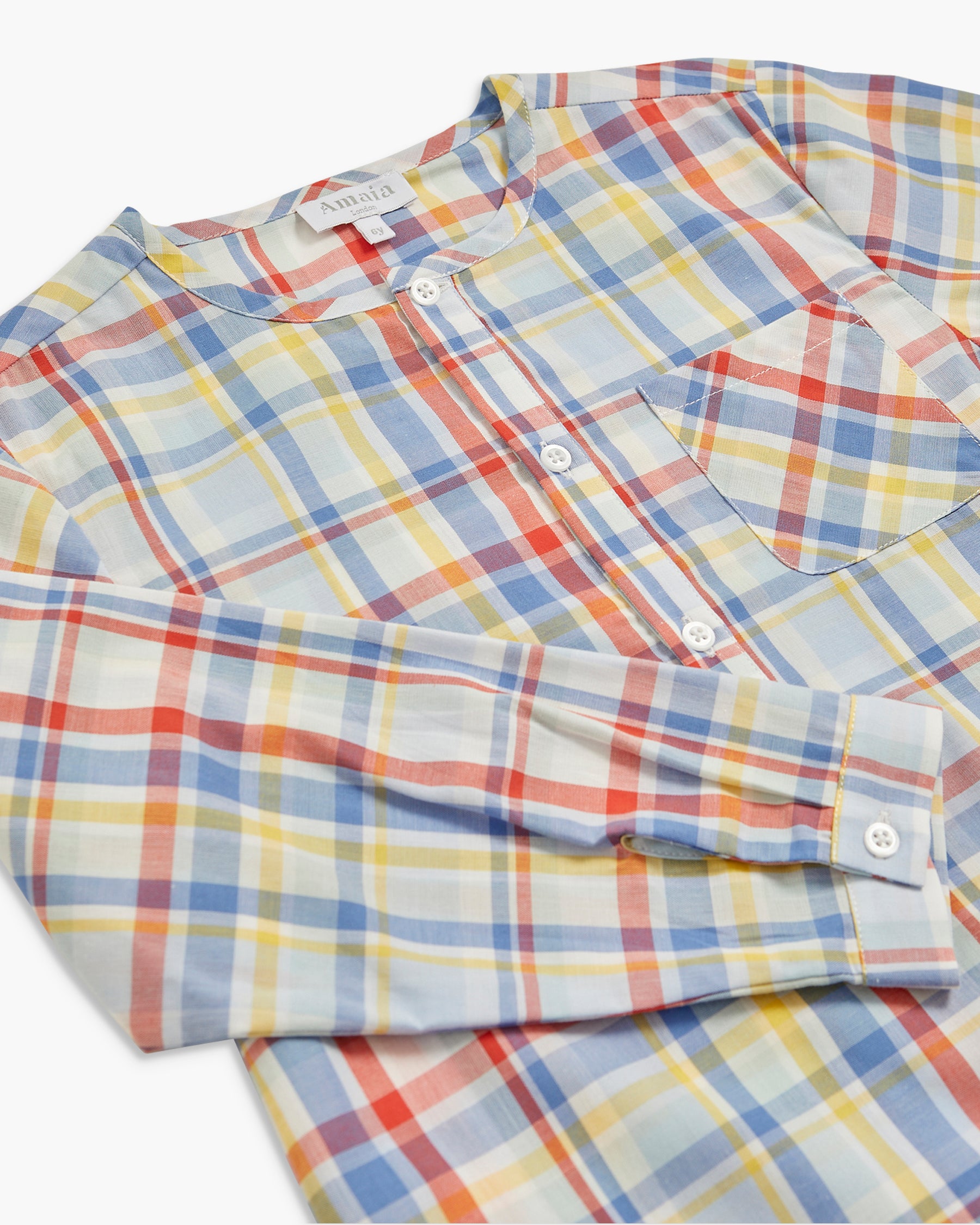 Folded multicolored plaid shirt on a white background