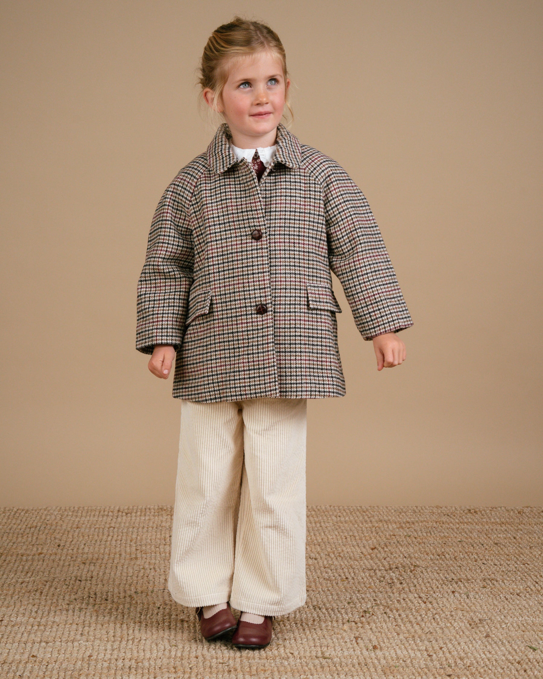 Girl wearing Checked Tweed Car Coat and ivory couduroy trousers