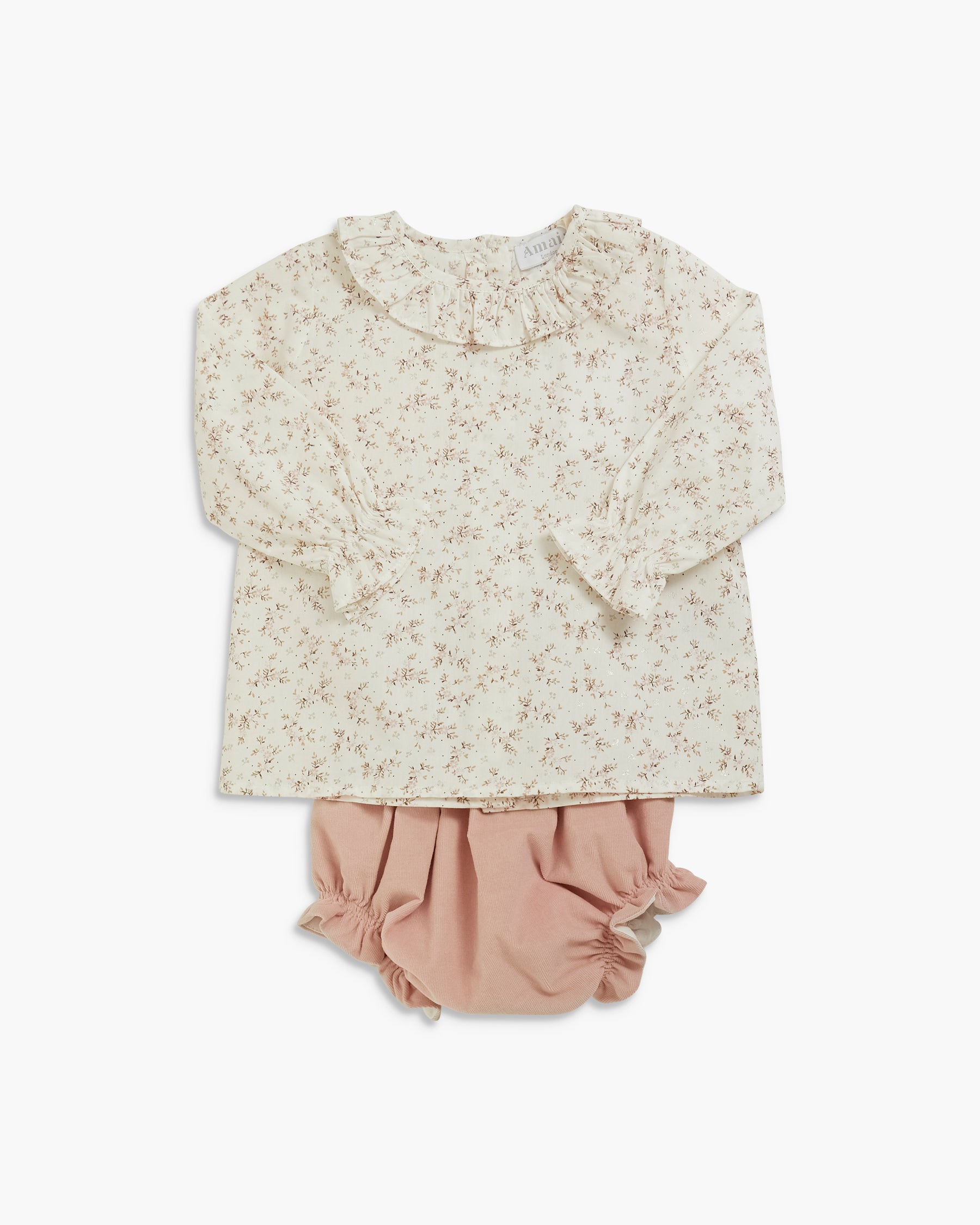 A toddler girl's two-piece outfit set featuring a long-sleeve cream blouse with a delicate beige floral print and a ruffled Peter Pan collar, paired with dusty pink ruffled bloomers, laid flat against a white background.