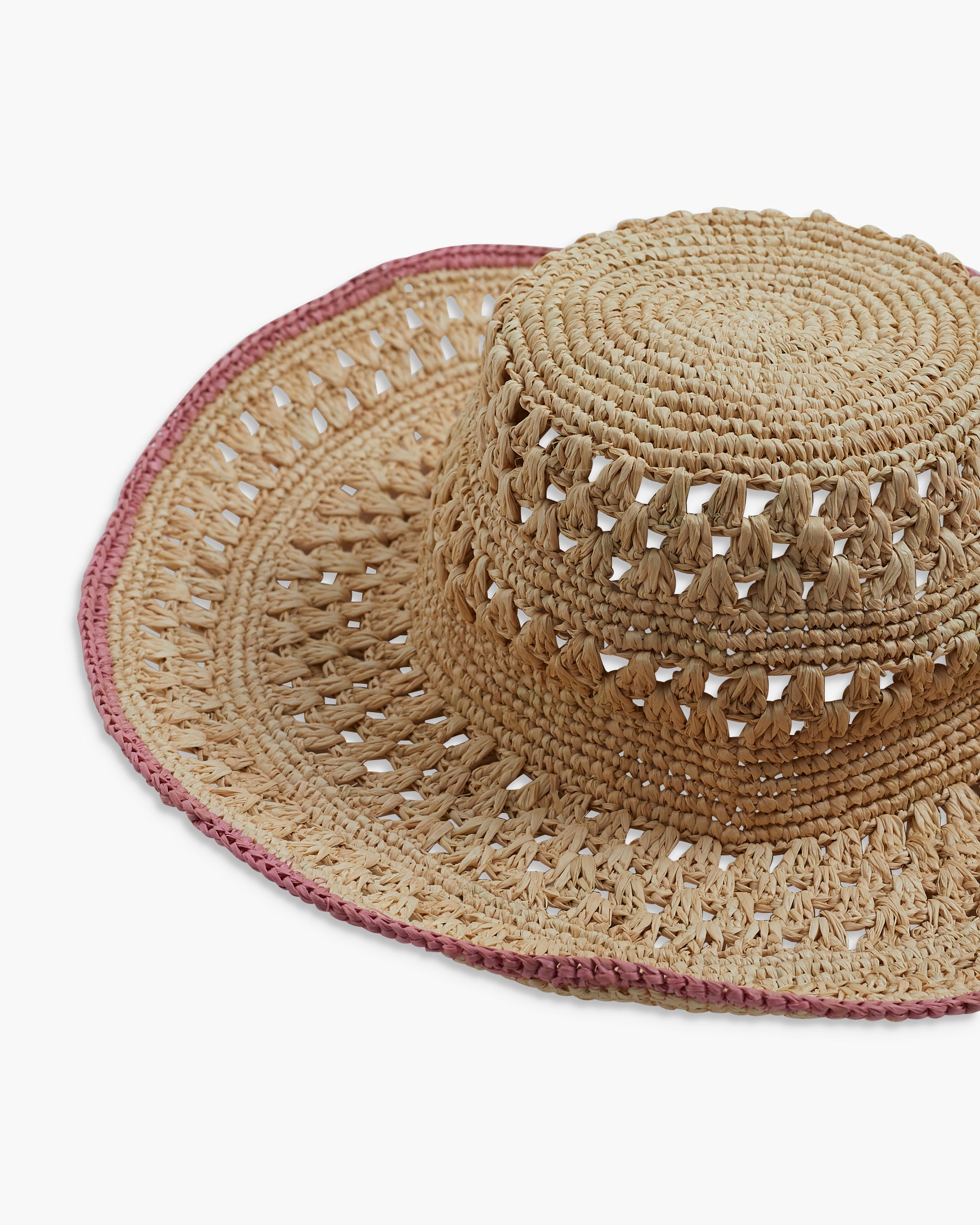 Beige straw hat with pink trim on a white background