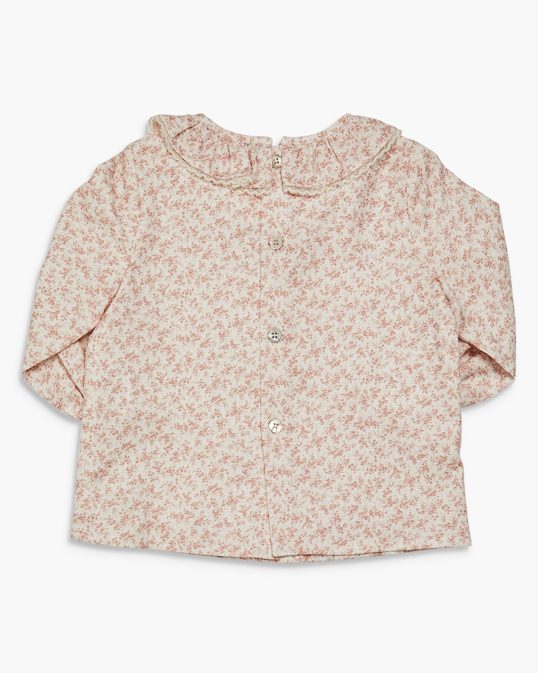 Floral patterned baby shirt on a white background
