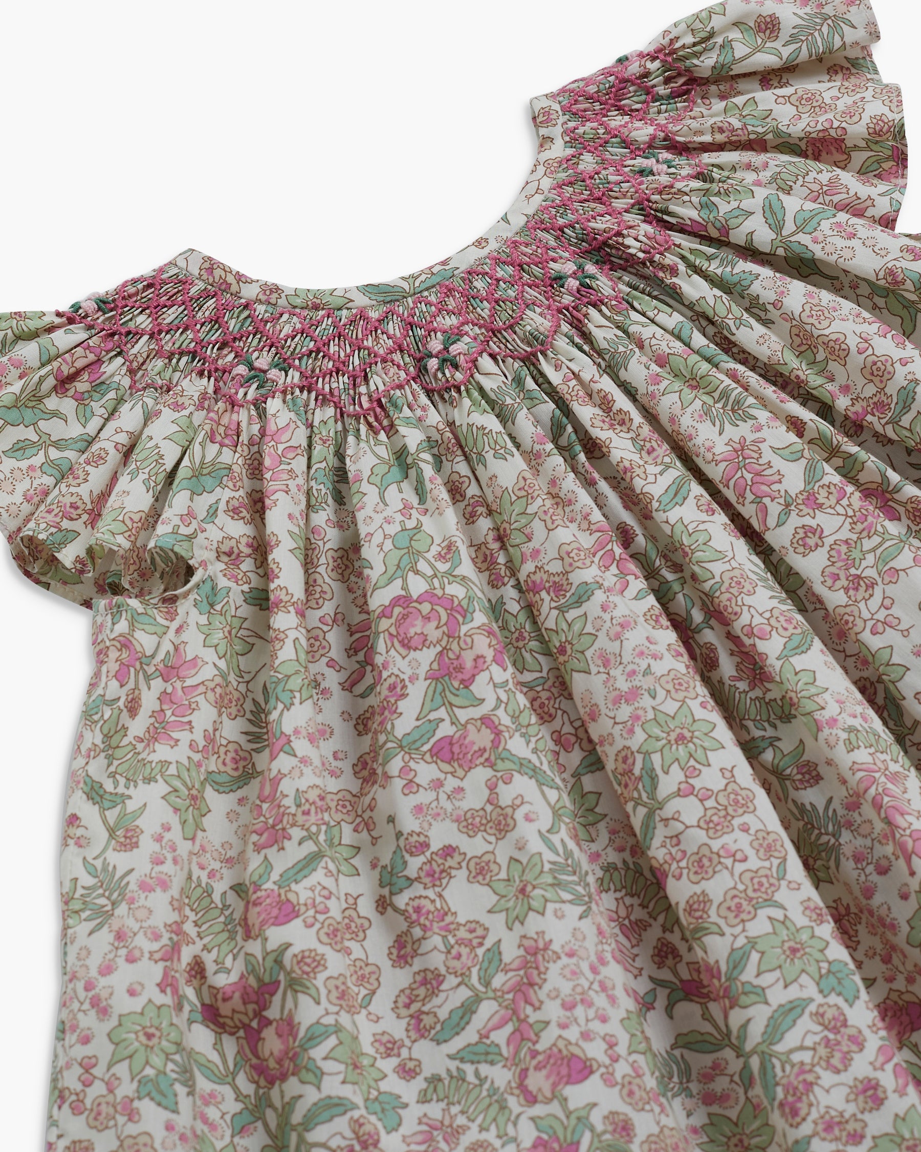 Floral dress with smocked neckline on a white background