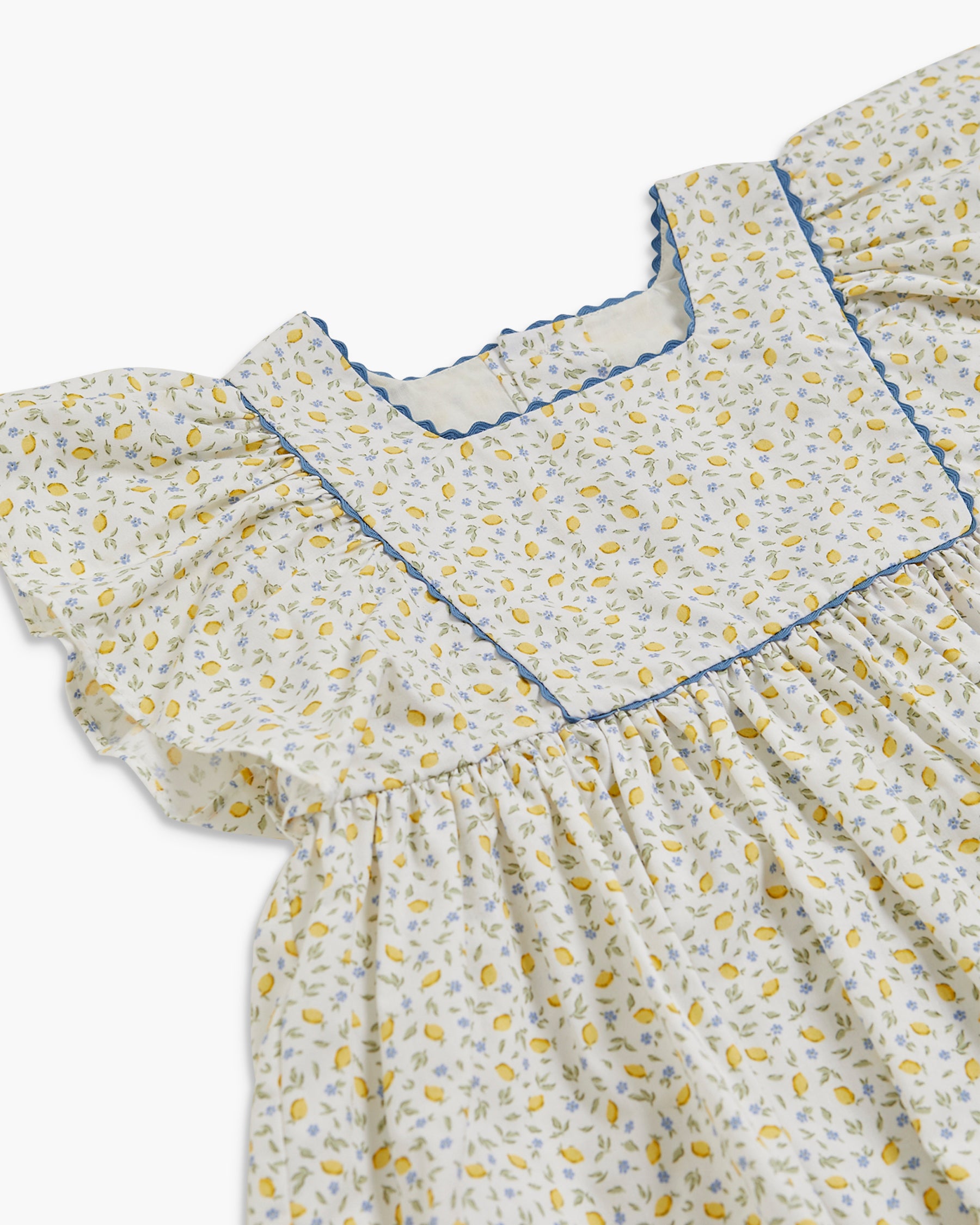 Floral dress with blue trim on a white background