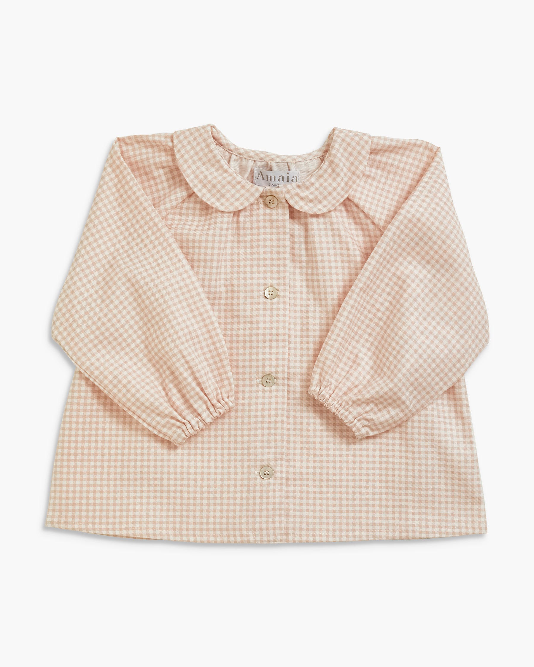 A long-sleeve baby blouse with a beige and white gingham pattern, featuring a ruffled Peter Pan collar and button-front closure, laid flat against a white background.