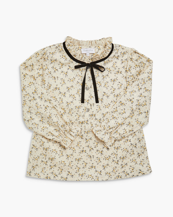 Floral blouse with a black ribbon on a white background