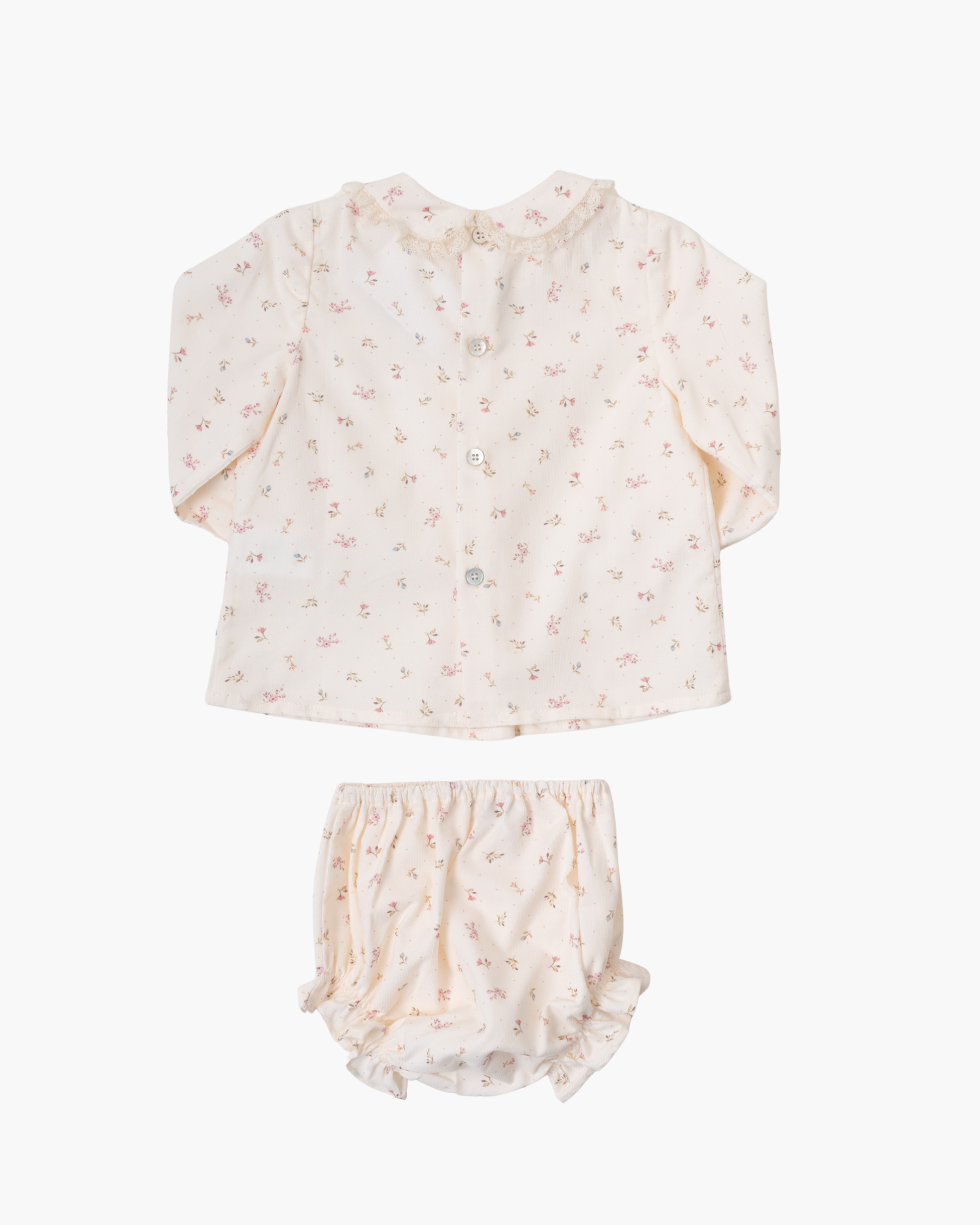 A two-piece baby outfit set featuring a long-sleeve button-up top and matching bloomers, both in a soft cream fabric with a delicate pink floral print, laid flat against a light gray background.