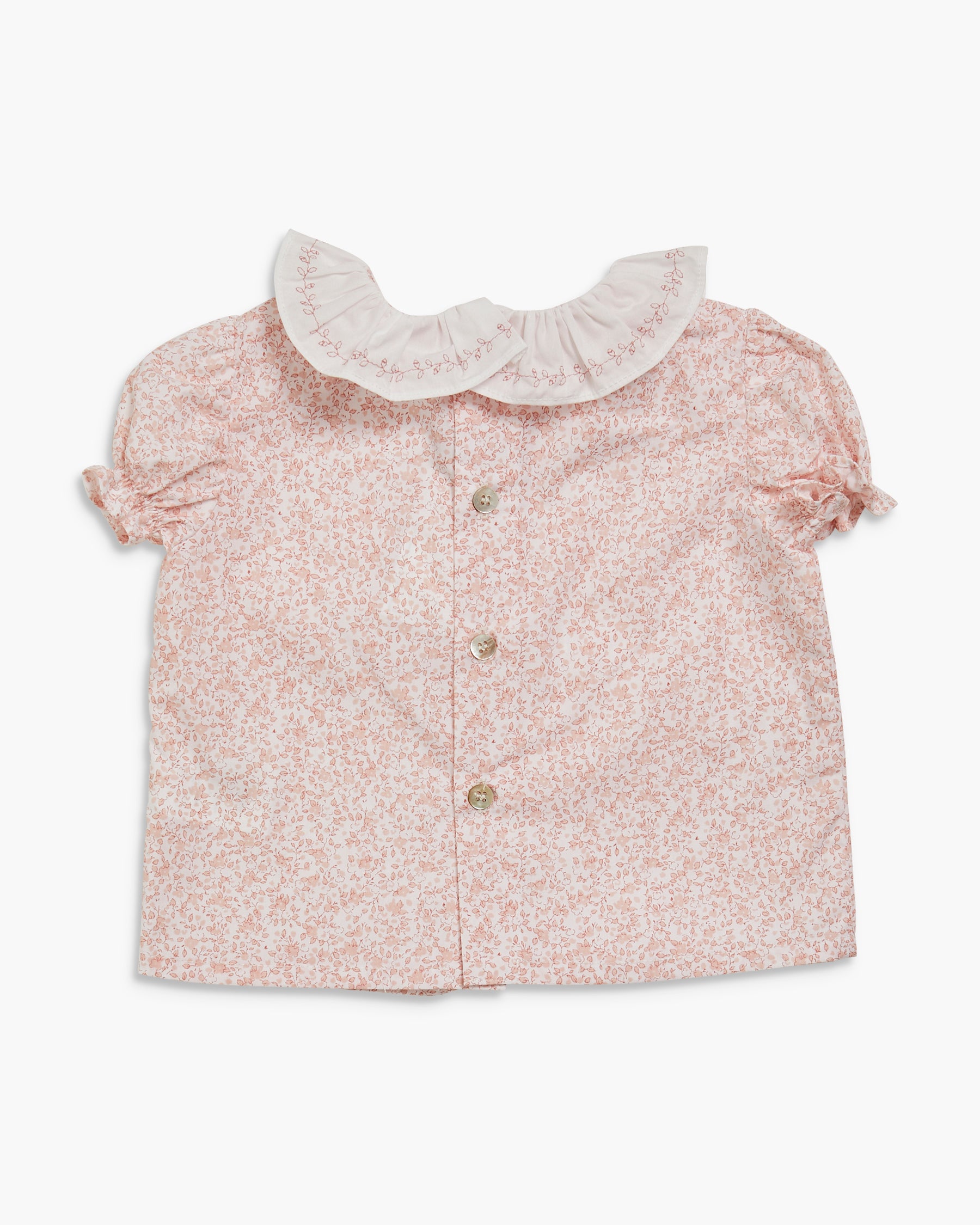 Floral blouse with lace collar on a white background