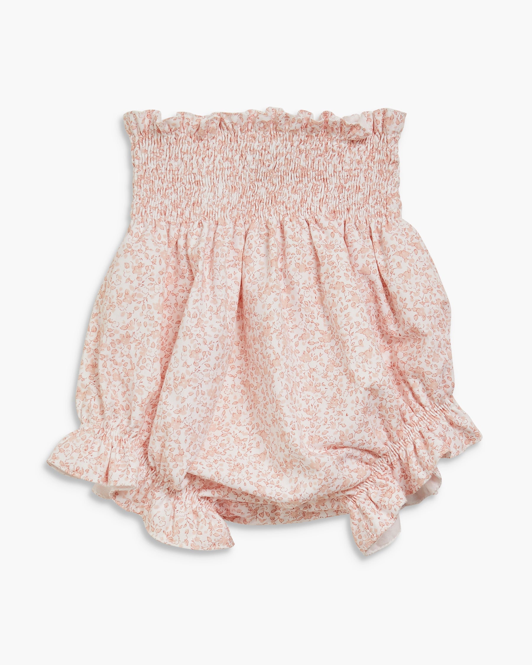 Floral patterned blouse with smocked waist on a white background