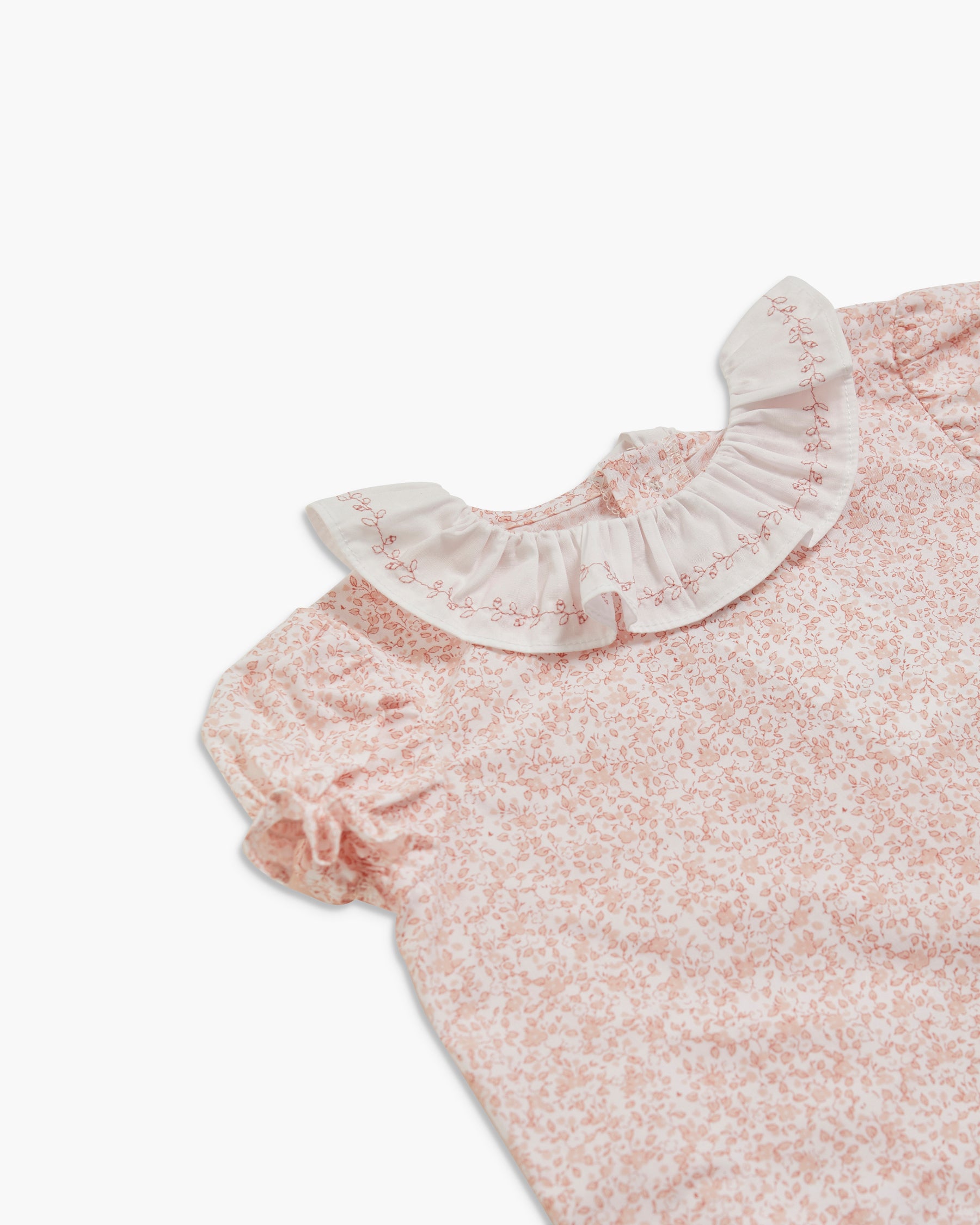 Floral dress with a ruffled collar on a white background