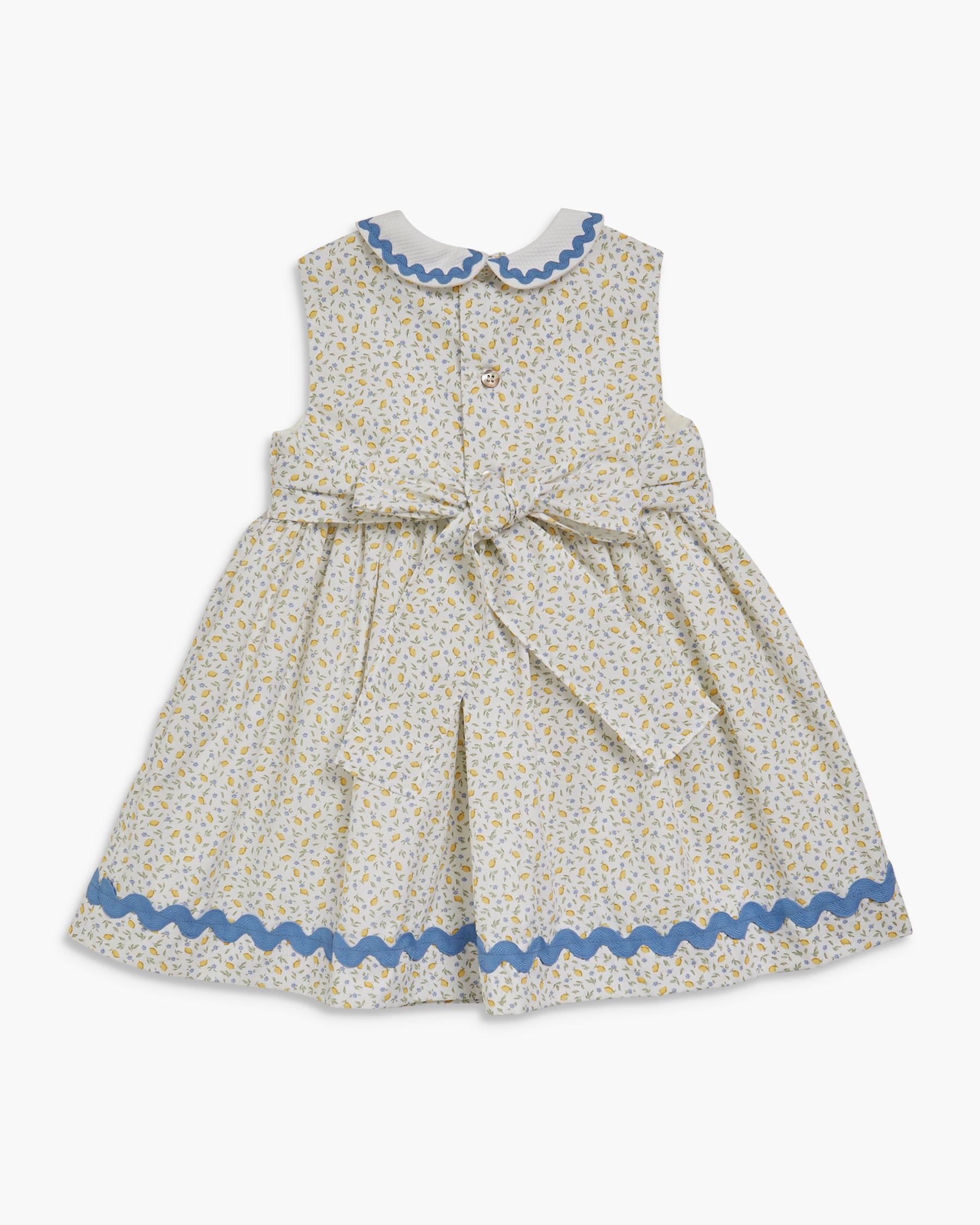 Children's dress with floral pattern and blue trim on a white background