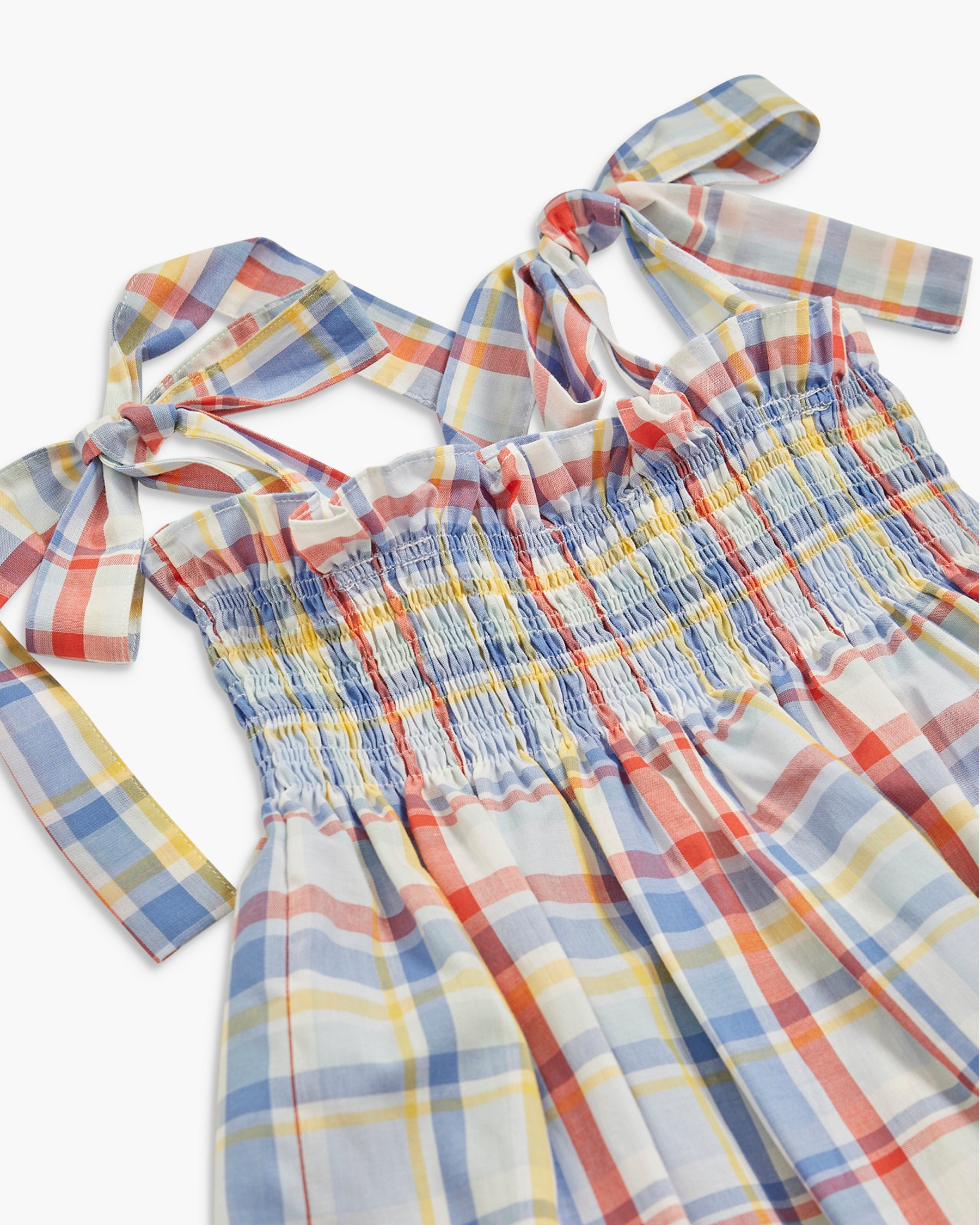 Plaid dress with bow details on a white background