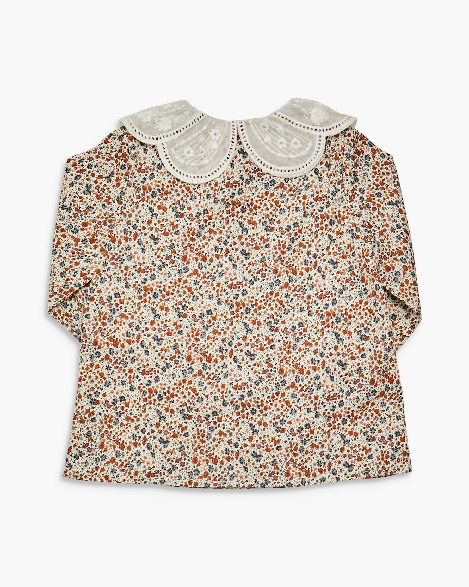 Floral blouse with lace collar on a white background