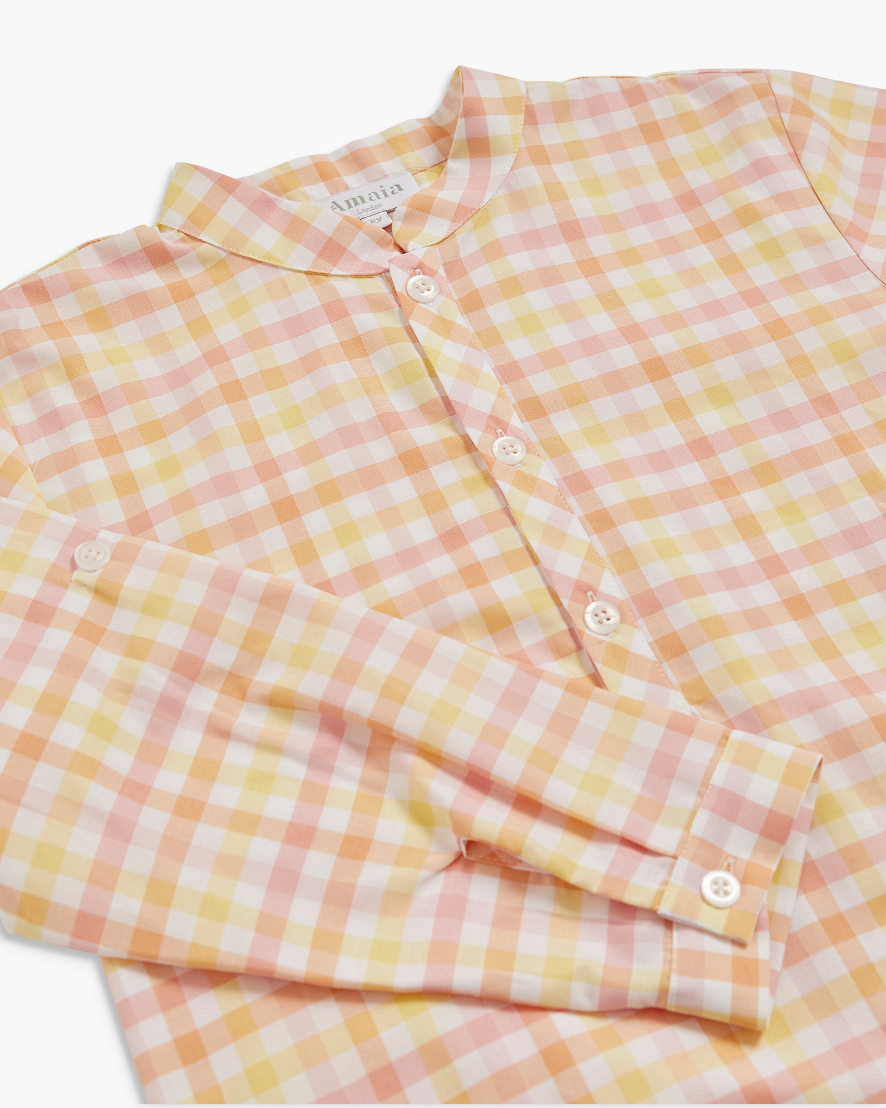 Yellow and pink checkered shirt on a white background