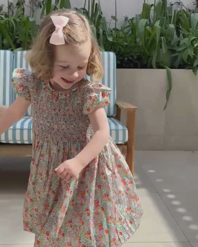 Young girl wearing a floral liberty dress