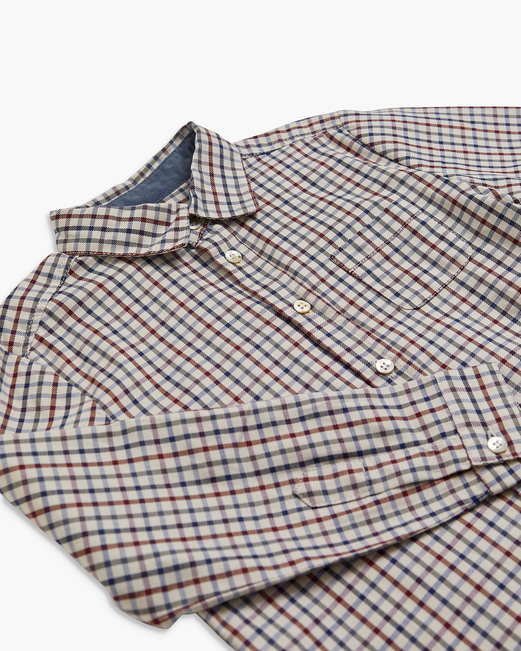 Folded plaid shirt on a white background